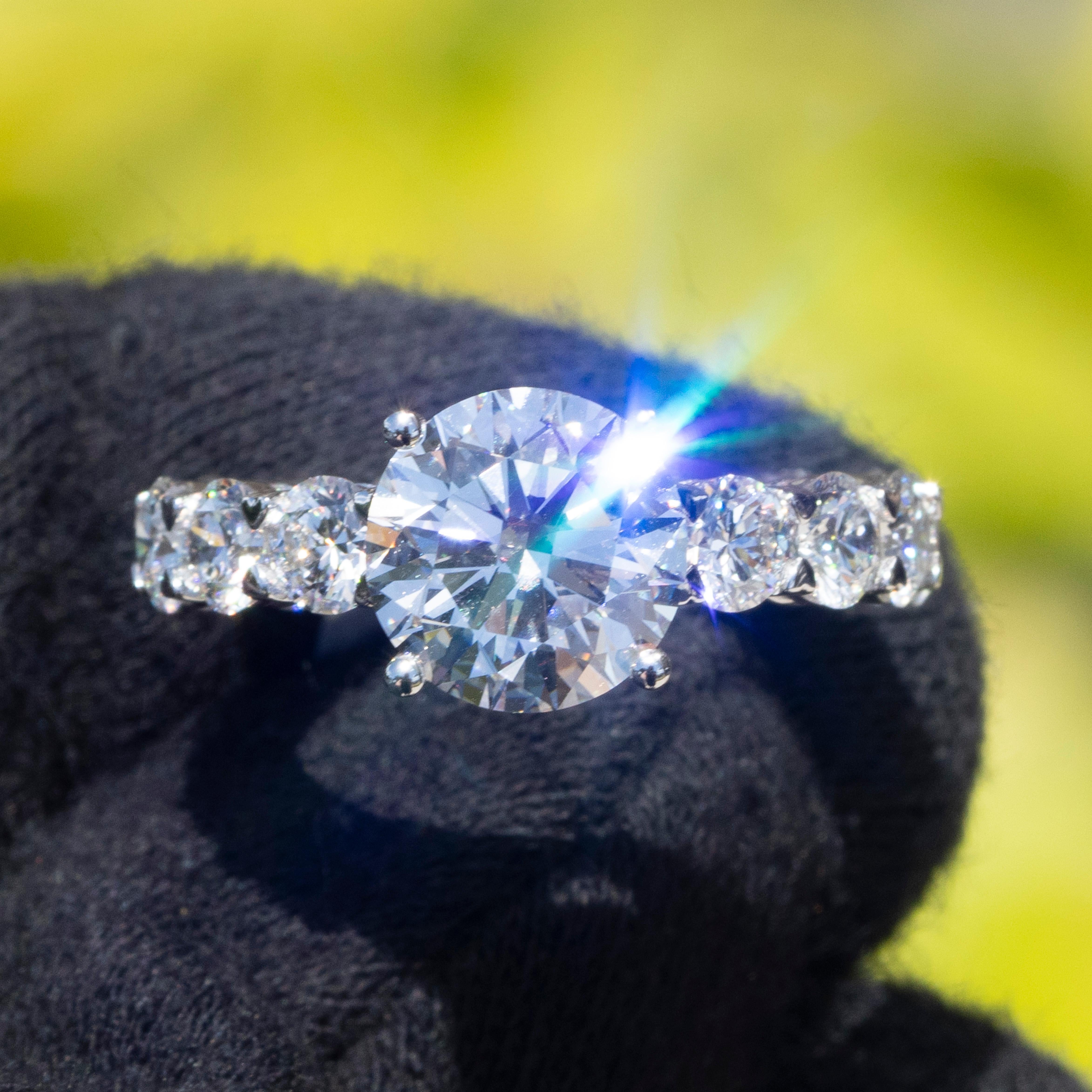 This stunning 18k white gold eternity ring features a total of 7.33 carats of natural round brilliant diamonds. The centerpiece is a GIA certified 3.43-carat diamond with D color and Flawless clarity. The diamonds are graded Excellent for cut,
