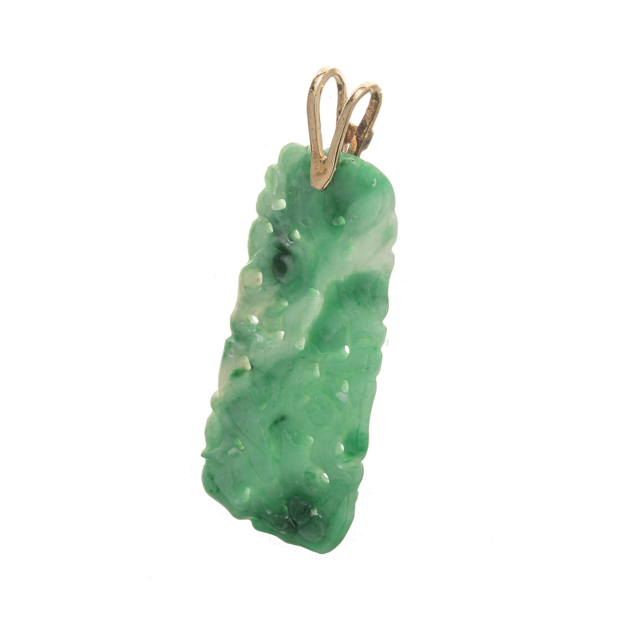 Bright green natural untreated certified jadeite jade pendant. Hand carved variegated flower jade with a 14k yellow gold bail. 

Variegated green and white rectangular Jadeite jade carving 42.9 x 19.2 x 3.3mm. Natural color, no dye no enhancement.