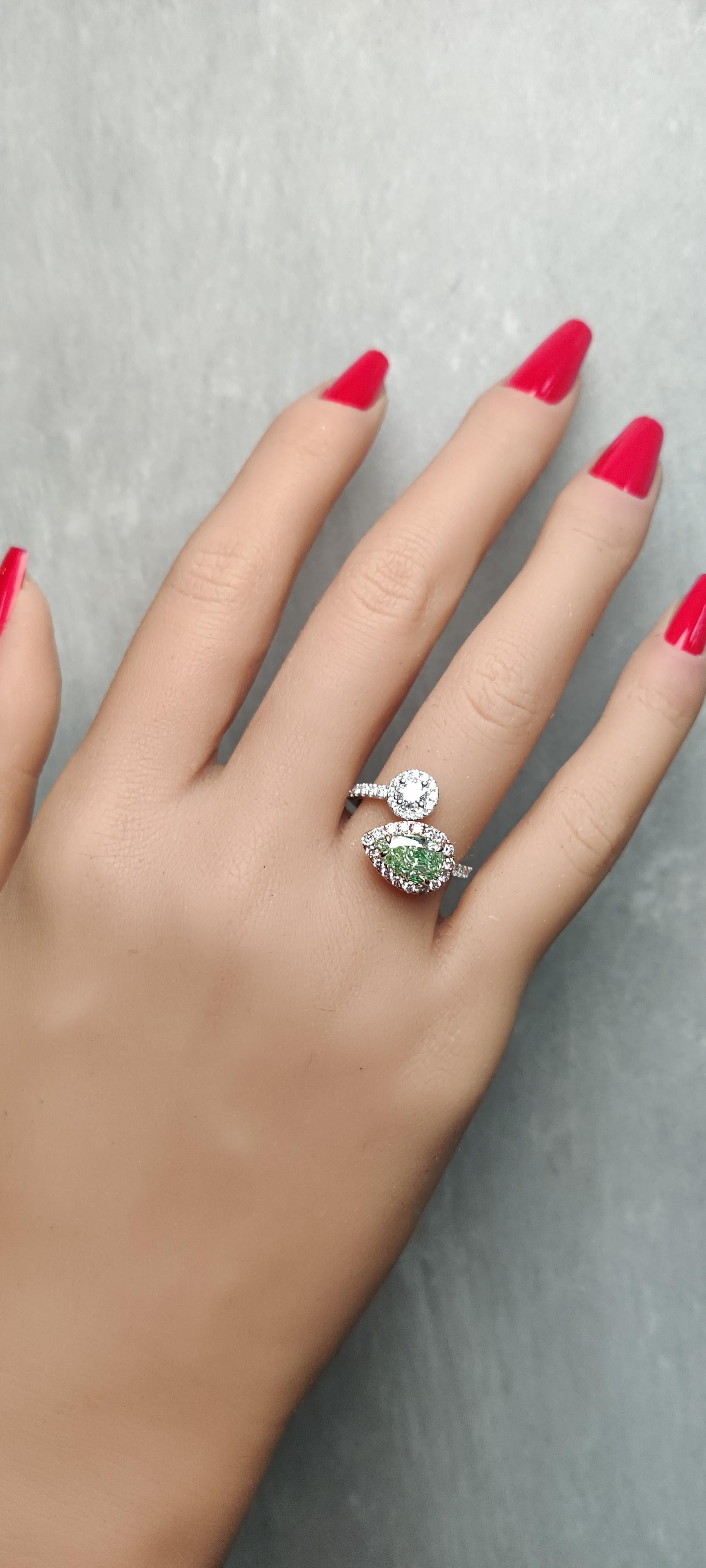 RareGemWorld's classic GIA certified diamond ring. Mounted in a beautiful 18K Rose and White Gold setting with a natural pear cut green diamond. The green diamond is surrounded by round natural white diamond melee and round natural pink diamond