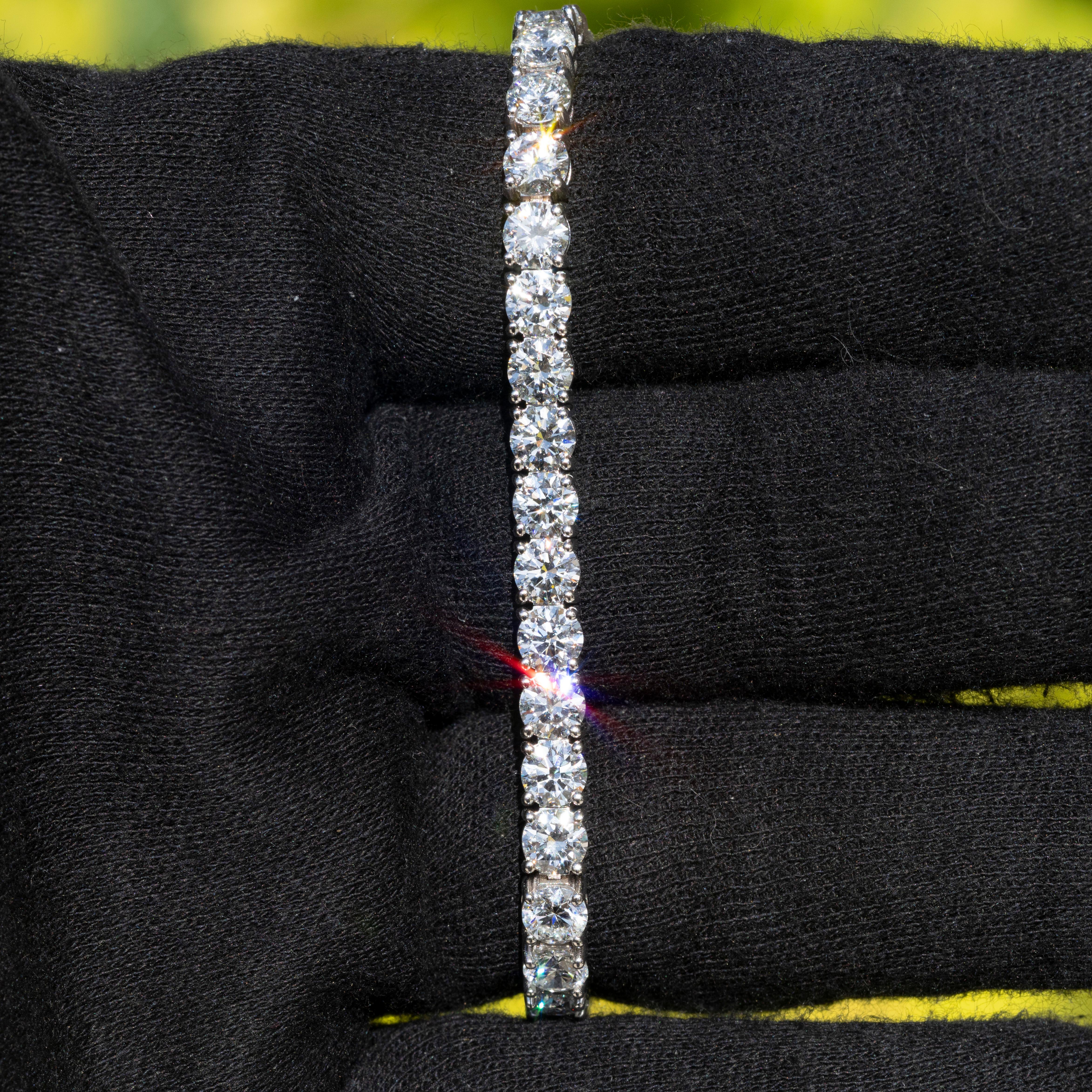 This exquisite 18k white gold tennis bracelet features 14.8 carats of natural round brilliant diamonds. The diamonds are GIA certified with D color and Internally Flawless clarity, and are graded Excellent for cut, polish, and symmetry. Weighing