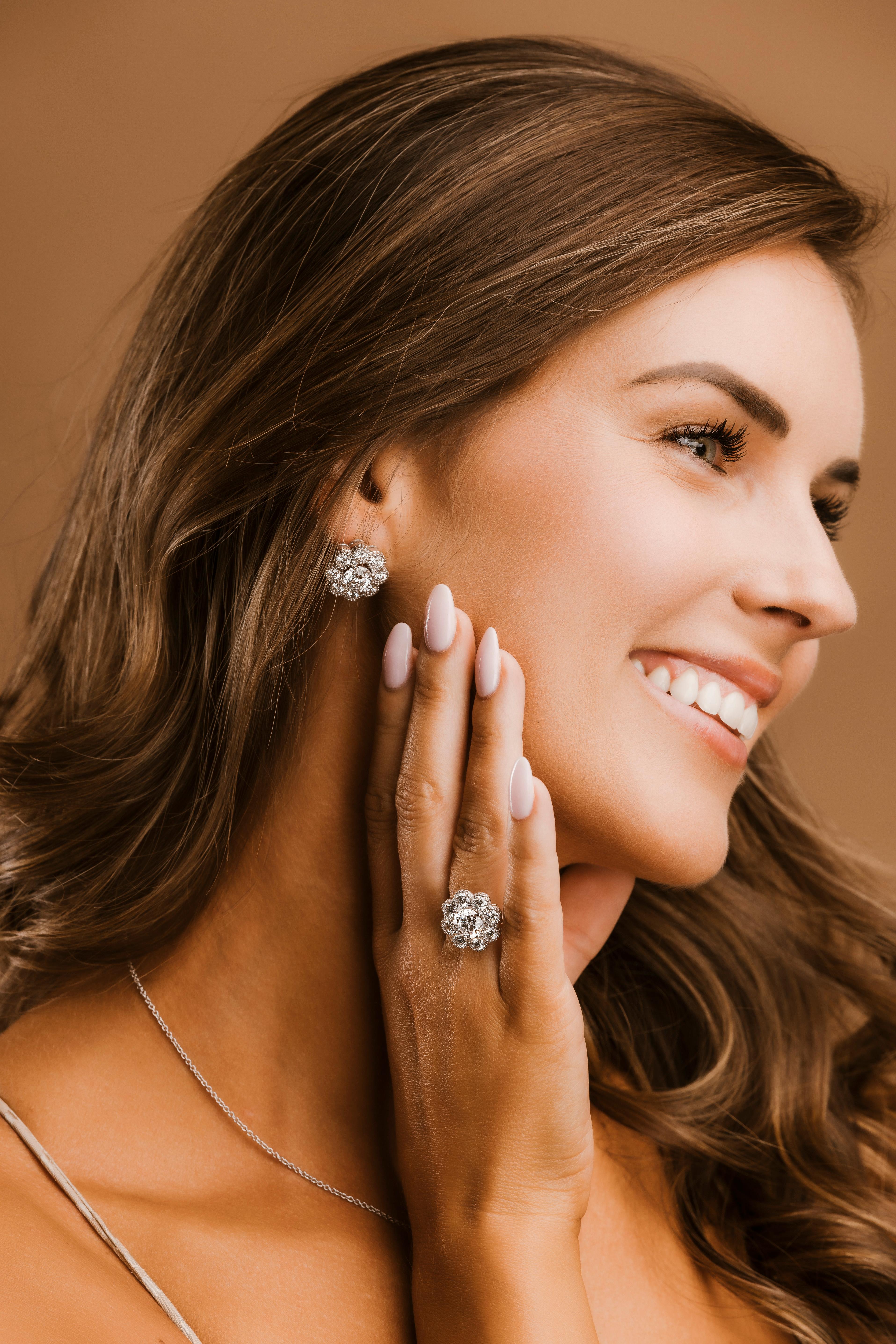 These stunning 18k white gold halo earrings feature a total of 8.2 carats of natural brilliant round diamonds. Each earring is set with a 2.02-carat diamond, GIA certified with D color and Internally Flawless clarity. The diamonds are graded