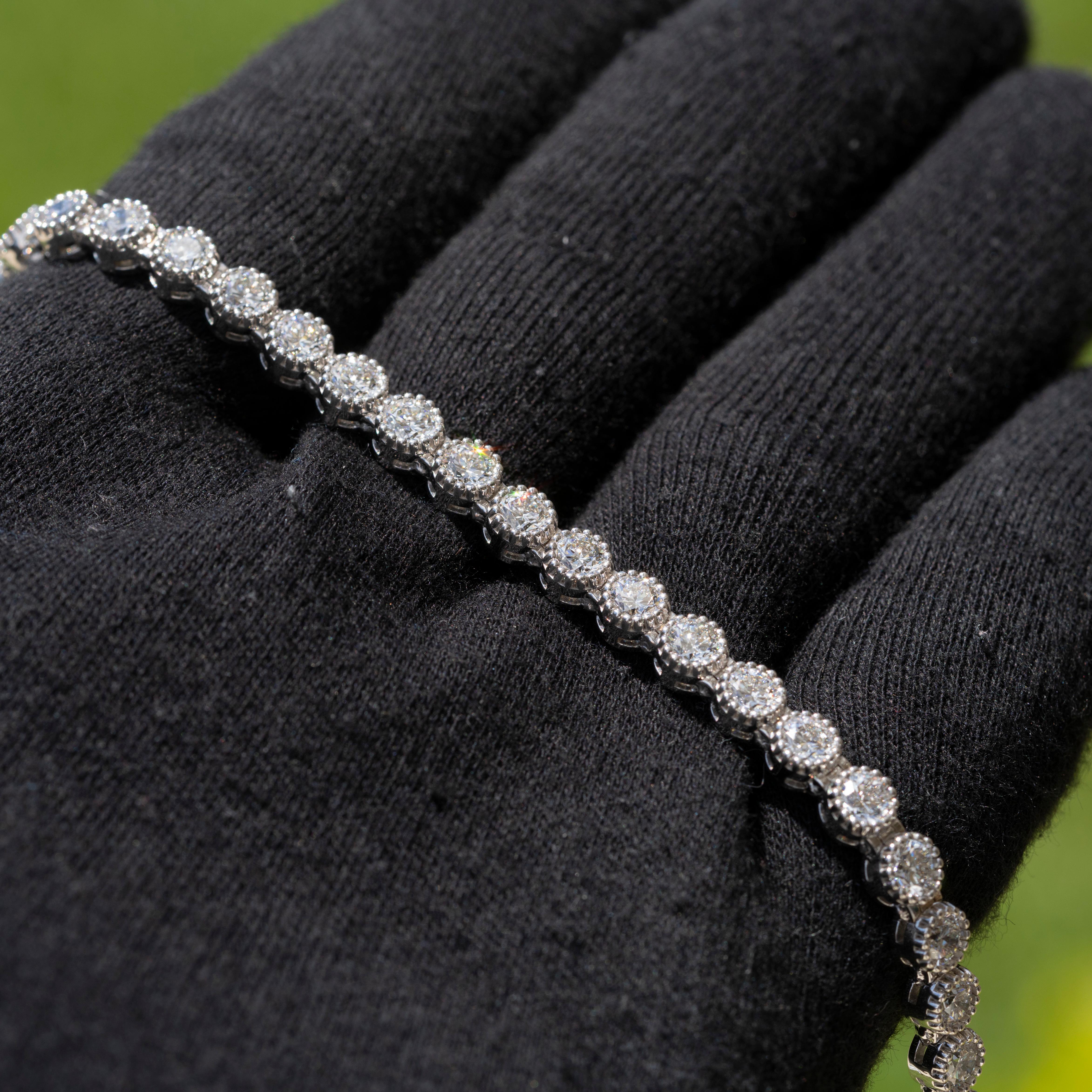 This stunning 18k white gold tennis bracelet features 9.6 carats of natural brilliant round diamonds. The diamonds are GIA certified with D color and Internally Flawless clarity, and are graded Excellent for cut, polish, and symmetry. Weighing 21.2