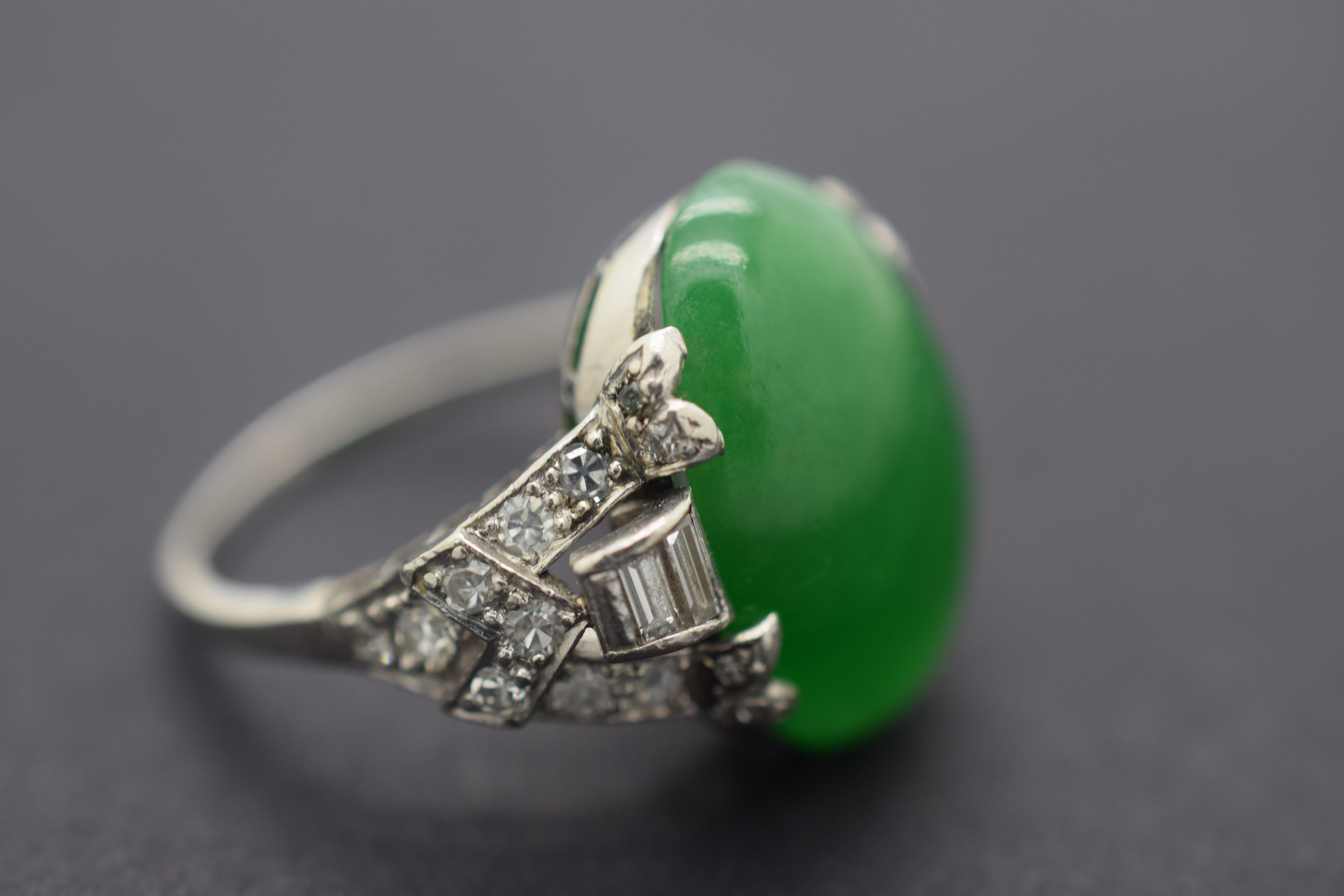 Gorgeous GIA certified natural color Jade ring. The GIA certificate number is  1186114100.  Center stone measures 17.40 x 12.40 x 5.85 mm. The Jade is a translucent beautiful  vibrant green color.  This elegant oval cut Jade gemstone is set in a