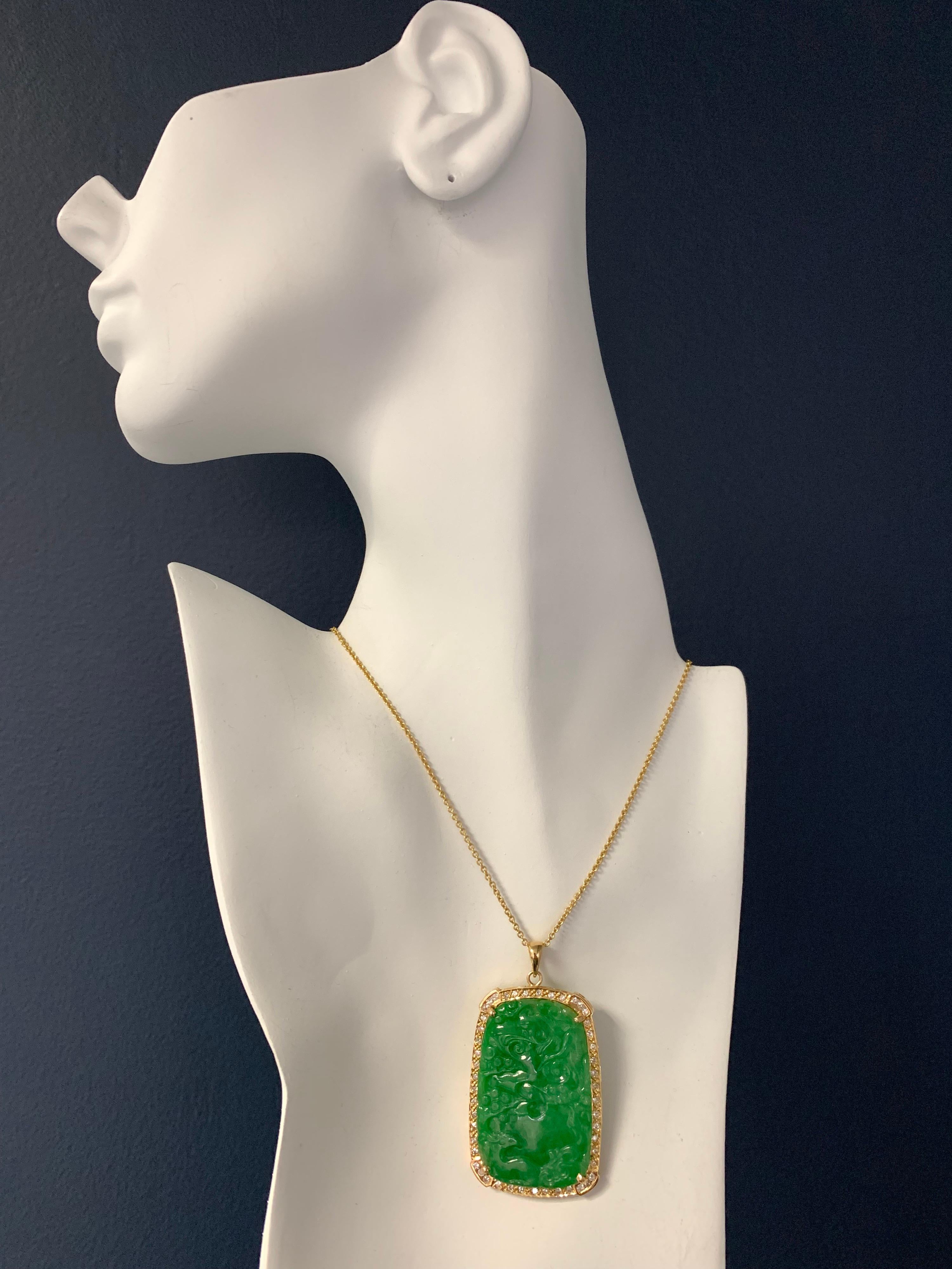 Rare GIA Certified Estate Natural Diamond and Jade 18k Yellow Gold Pendant measuring 43.01x28.25x4.44mm.

The Pendant is set with a Natural Translucent Jadeite Jade Green Carving with Natural Color, no indications of impregnation. The total weight