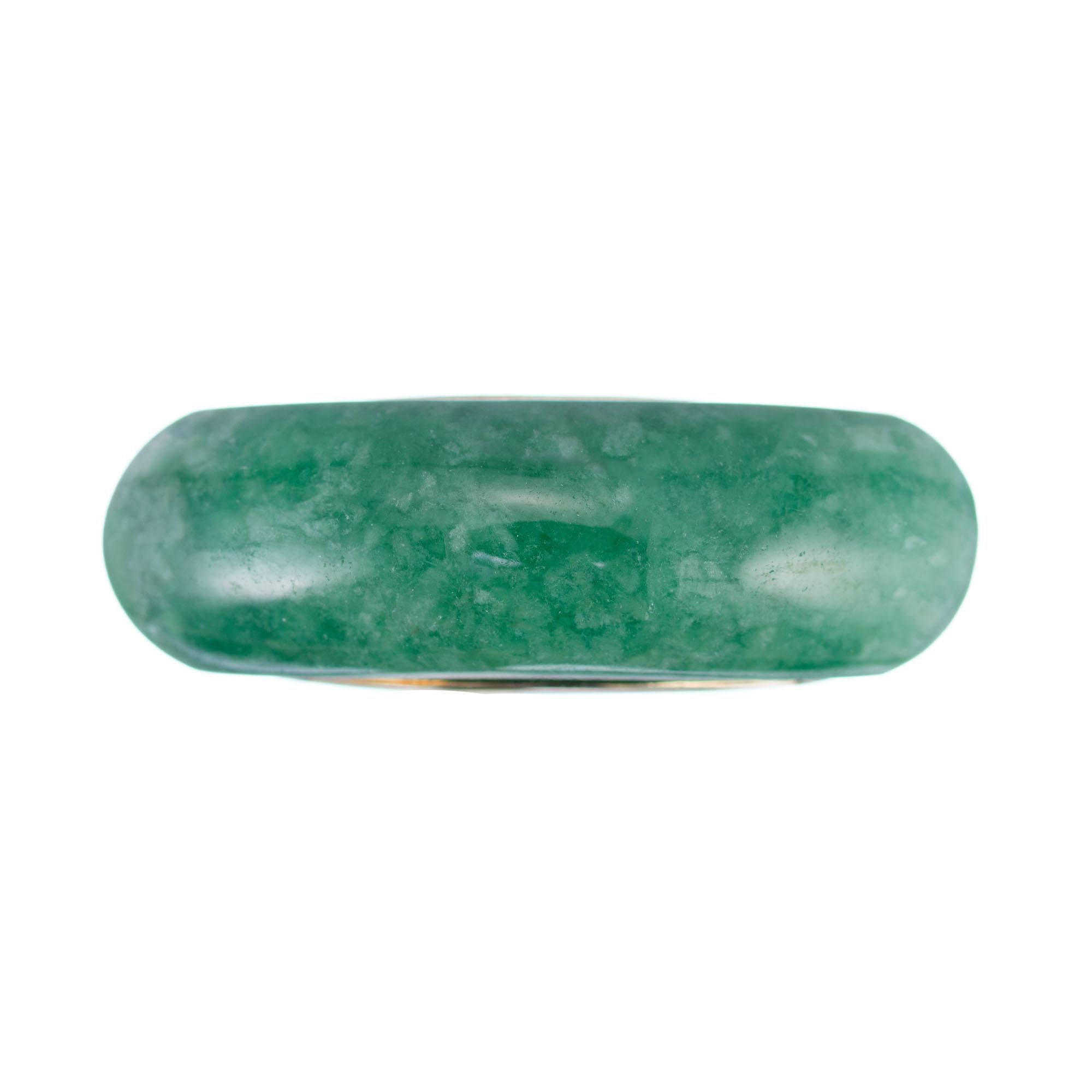 1950s GIA certified natural untreated Jadeite Jade solid 18k yellow gold saddle ring.

1 oval green arc shape cabochon untreated Jadeite Jade, 25.03 x 7.94 x 5.54mm, GIA certificate #2175214420
Size 7.75 and sizable
18k yellow gold
Tested and
