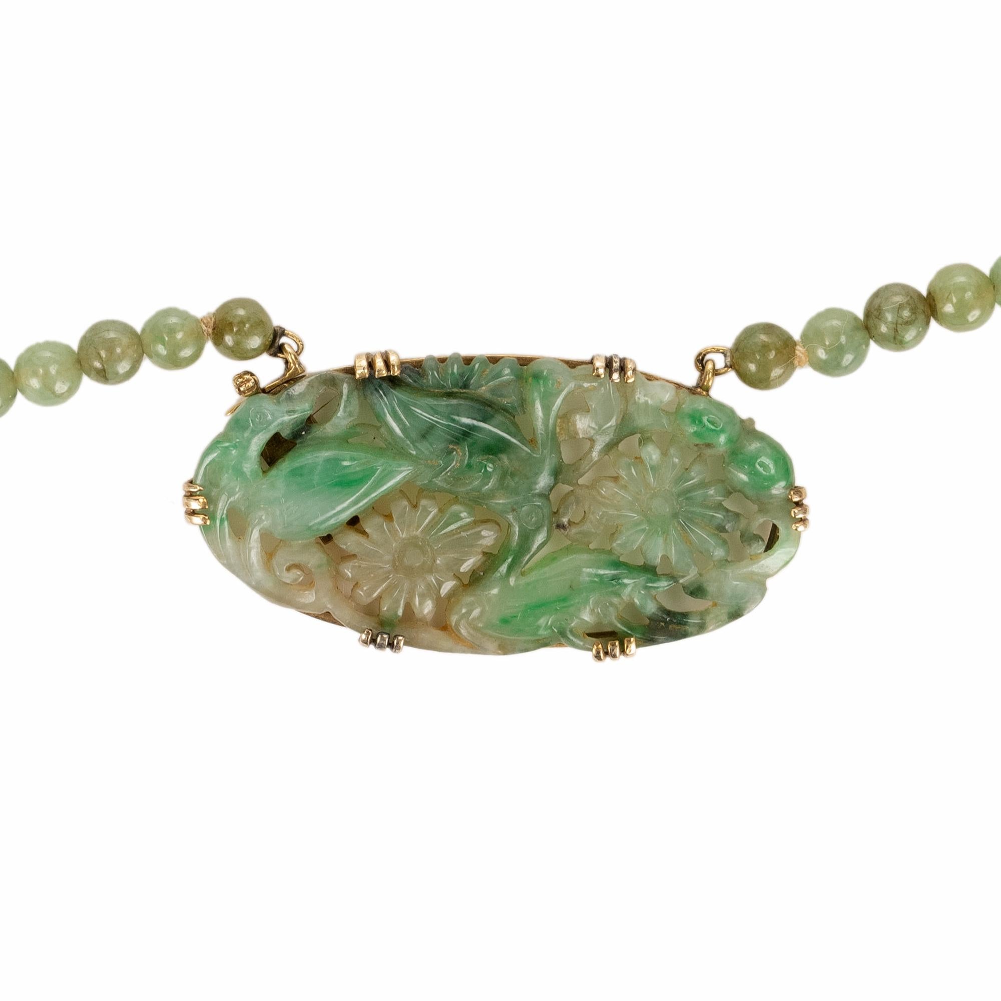 1950's GIA certified jadeite Jade graduated bead necklace with curved oval clasp and 14k gold settings 

1 pierced carving mottled grayish green jadeite jade, GIA Certificate # 2193985517
81 mottled grayish green jadeite jade beads 
Total Length: 20