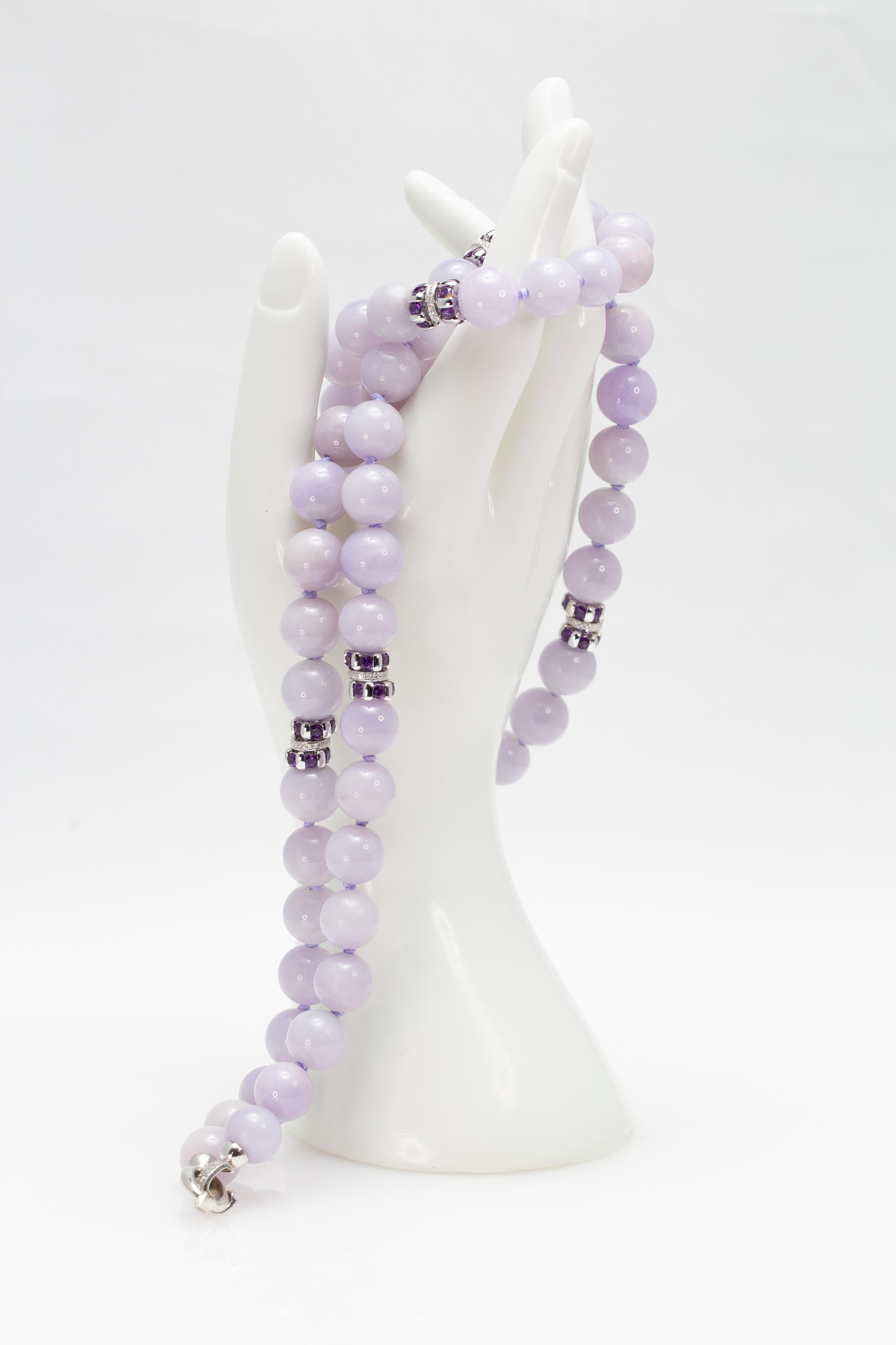 A GIA certified natural lavender Jadeite Jade straight strand necklace from the 1960s- 1970s, with Amethyst and Diamond rondels and 18K white gold. Attracting our attention with its gorgeous 12.5 to 13.5 mm natural lavender beads, this American
