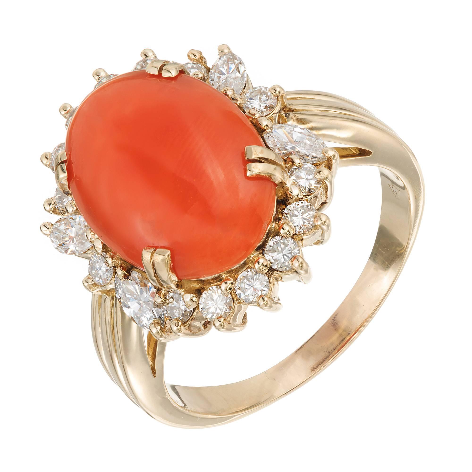 Mid-century polished GIA certified natural orange Coral and diamond cocktail ring. Surrounded by a halo of round and Marquise diamonds in a 14k yellow gold setting. 

14k yellow gold 
1 oval cabochon orange Coral 14.07 x 10.07 x 3.45mm
14 round full
