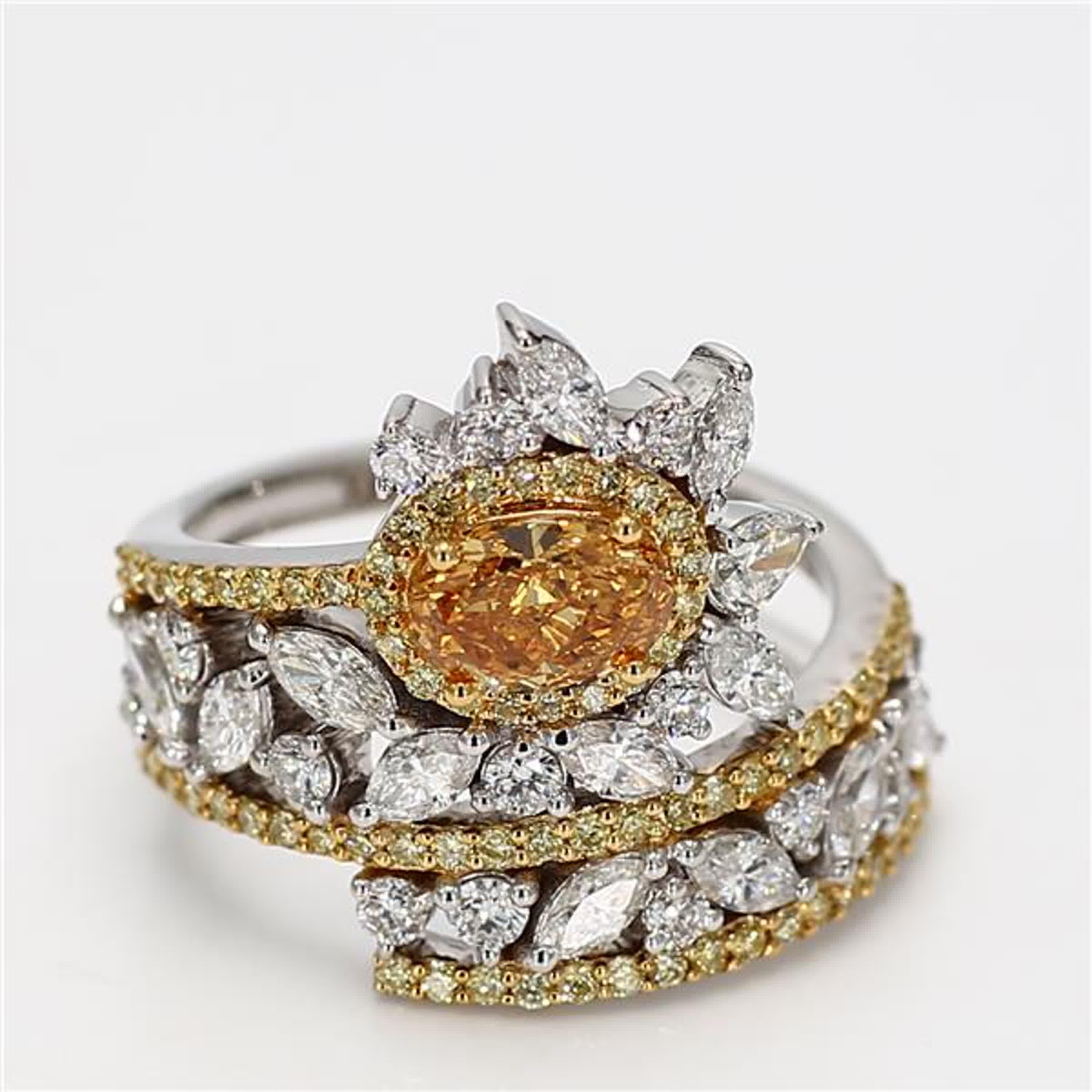 RareGemWorld's classic GIA certified diamond ring. Mounted in a beautiful 18K Yellow and White Gold setting with a natural oval cut orangy yellow diamond. The orangy yellow diamond is surrounded by natural marquise cut white diamonds, natural pear