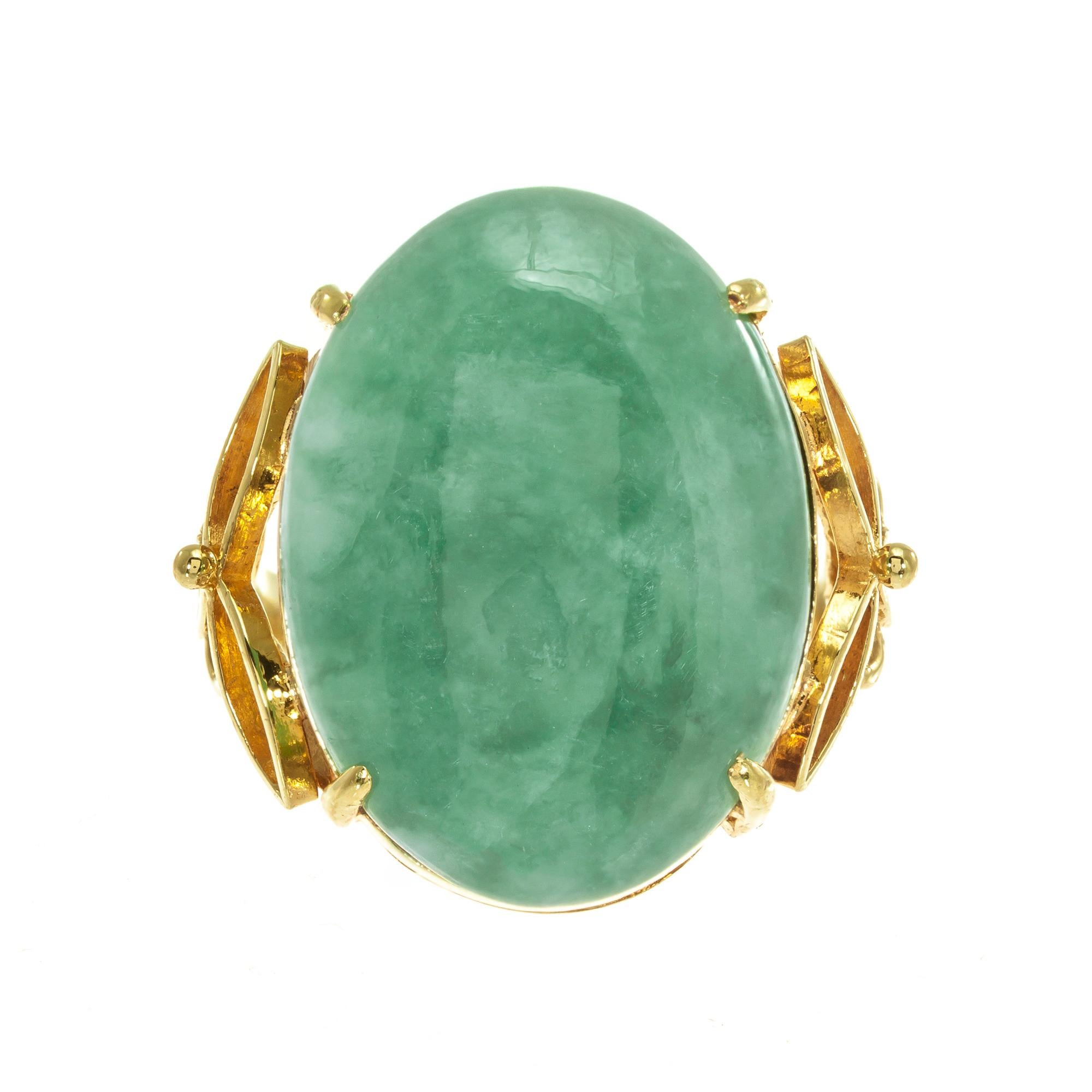 Natural well-polished oval Jadeite Jade center stone set in 18k yellow gold cocktail ring. GIA certified

1 double cabochon mottled green Jadeite Jade GIA Certificate # 6191993294
Size 5 and sizable 
18k Yellow Gold
Stamped: 75
Hallmark:
7.8