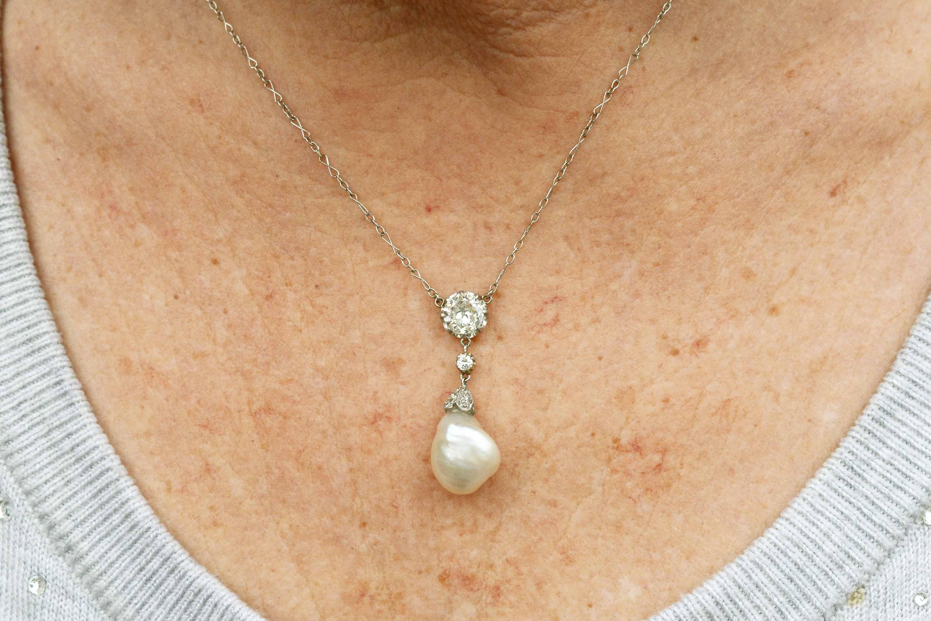 The Nampa antique natural pearl diamond pendant necklace centers on an intriguing, lustrous, large and rare GIA certified South Sea pearl. Suspended by an over 1 carat diamond solitaire, the lavalier drop style dating to the Belle Epoque or