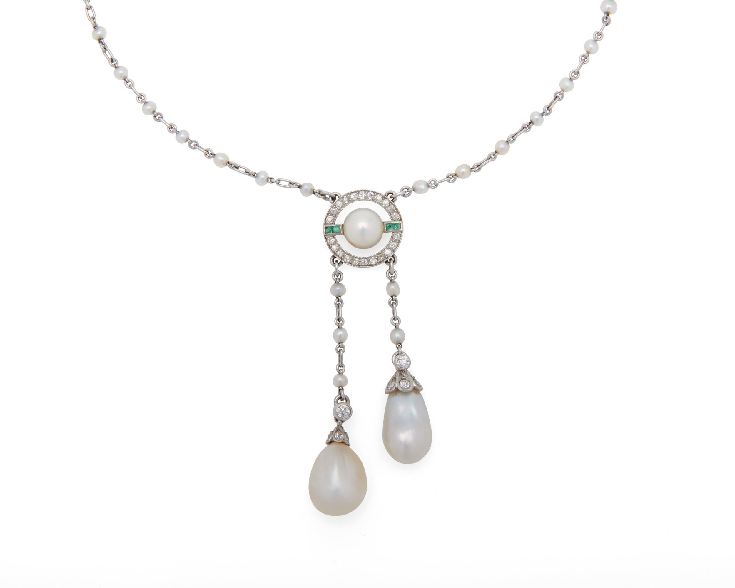 This delicate piece features a centering button pearl, which is intricately framed by square-cut emeralds and full-cut diamonds and suspending two natural near-drop-shaped pearls, all set in platinum.

Lariat length measures: 1.5 inches.