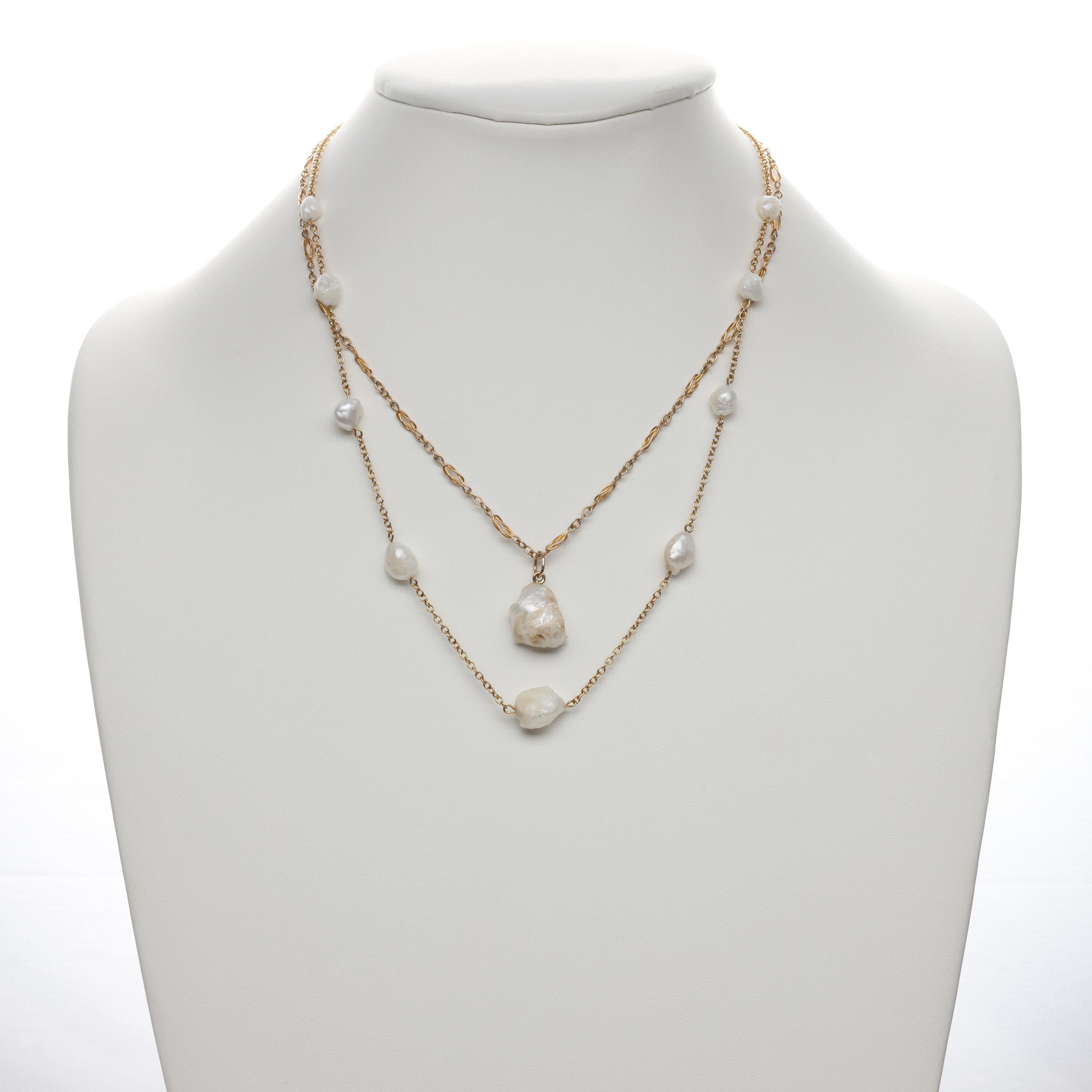 This is a rare and breathtaking natural river pearl parure featuring GIA-certified natural (uncultured) river pearls in composition with buttery 14K yellow gold to create a necklace, a pendant and a luxurious pair of dangle earrings. I believe the