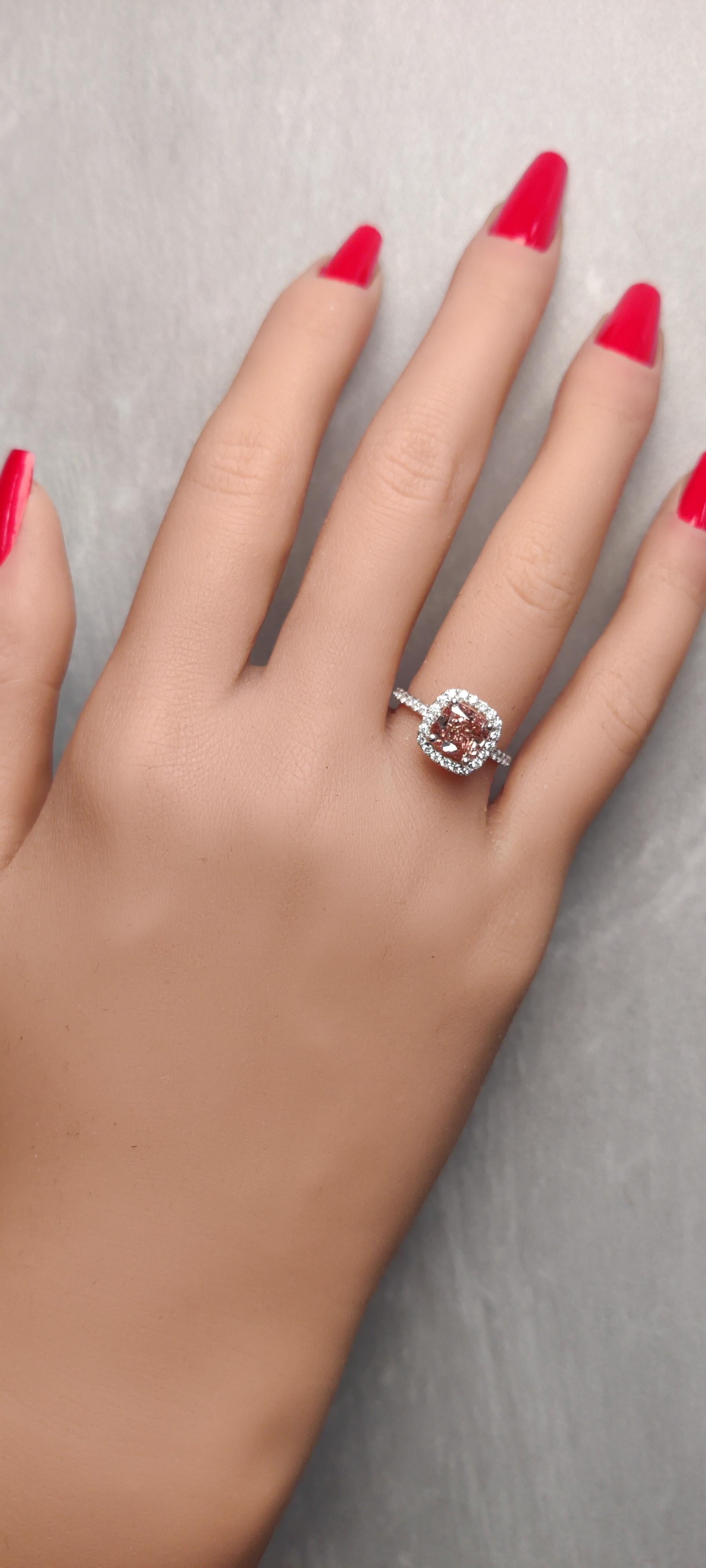 RareGemWorld's classic GIA certified diamond ring. Mounted in a beautiful 18k white gold setting with a natural cushion cut pink diamond. The pink diamond is surrounded by  round natural white diamond melee. This ring is guaranteed to impress and