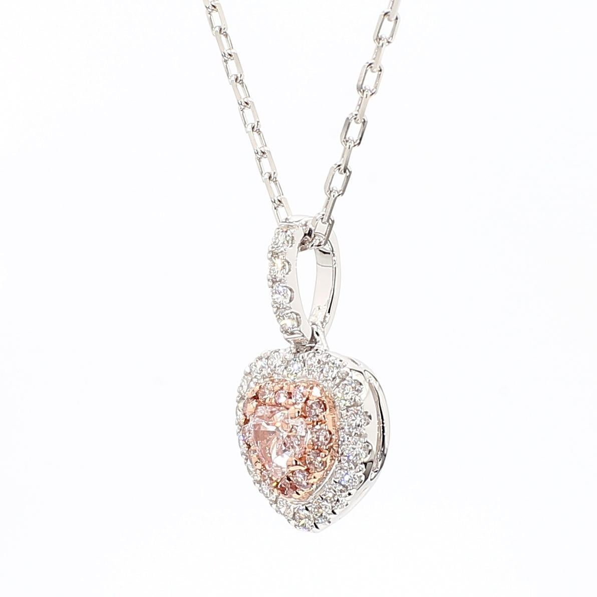 RareGemWorld's beautiful GIA certified diamond pendant. Mounted in a beautiful 18K Rose and White Gold setting with a natural heart cut pink diamond. The pink diamond is surrounded by round natural pink diamond melee and round natural white diamond