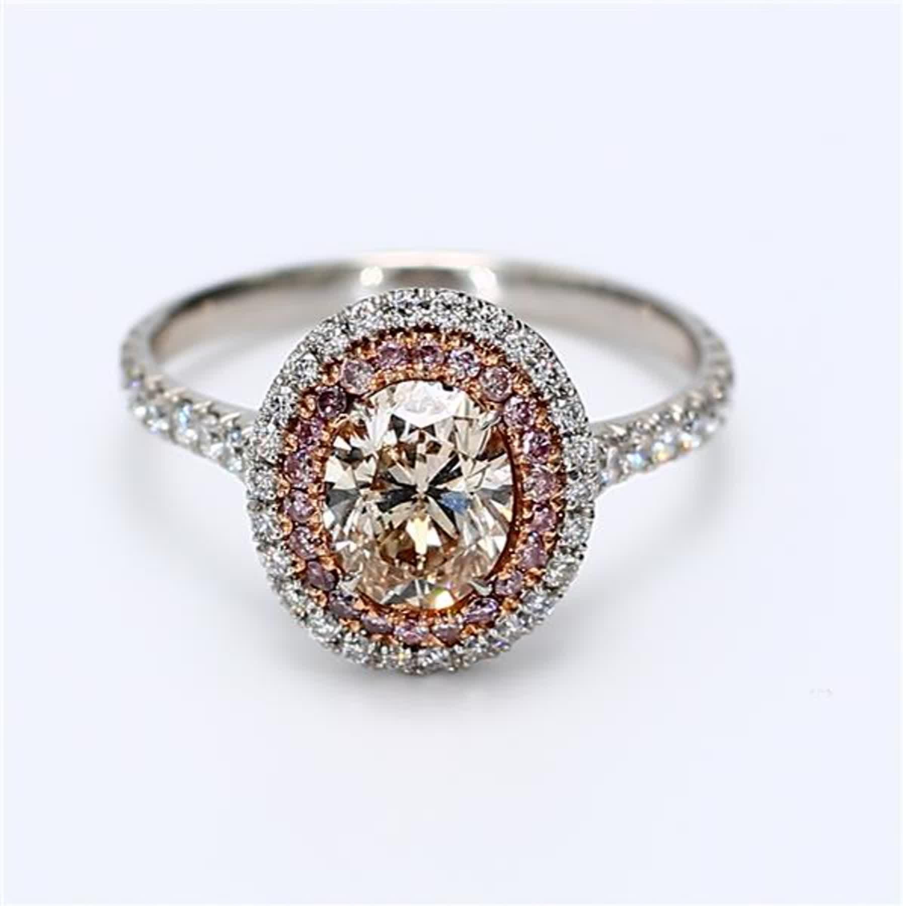 RareGemWorld's classic GIA certified diamond ring. Mounted in a beautiful 18K White Gold setting with a natural oval cut pink diamond. The pink diamond is surrounded by round natural pink diamond melee and round natural white diamond melee. This