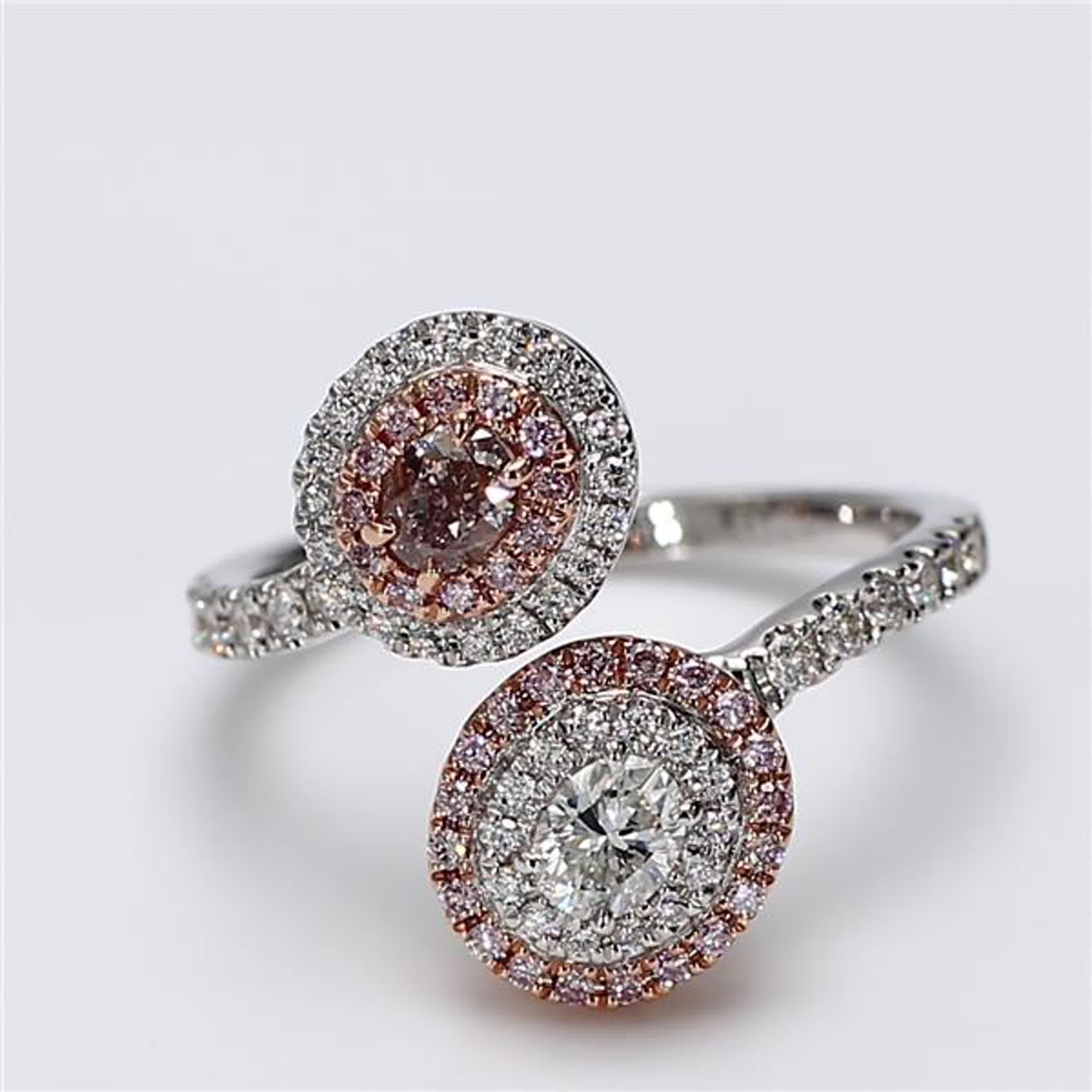 RareGemWorld's classic GIA certified diamond ring. Mounted in a beautiful 18K Rose and White Gold setting with a natural oval cut pink diamond as well as a natural oval cut white diamond. The oval diamonds are surrounded by round natural pink