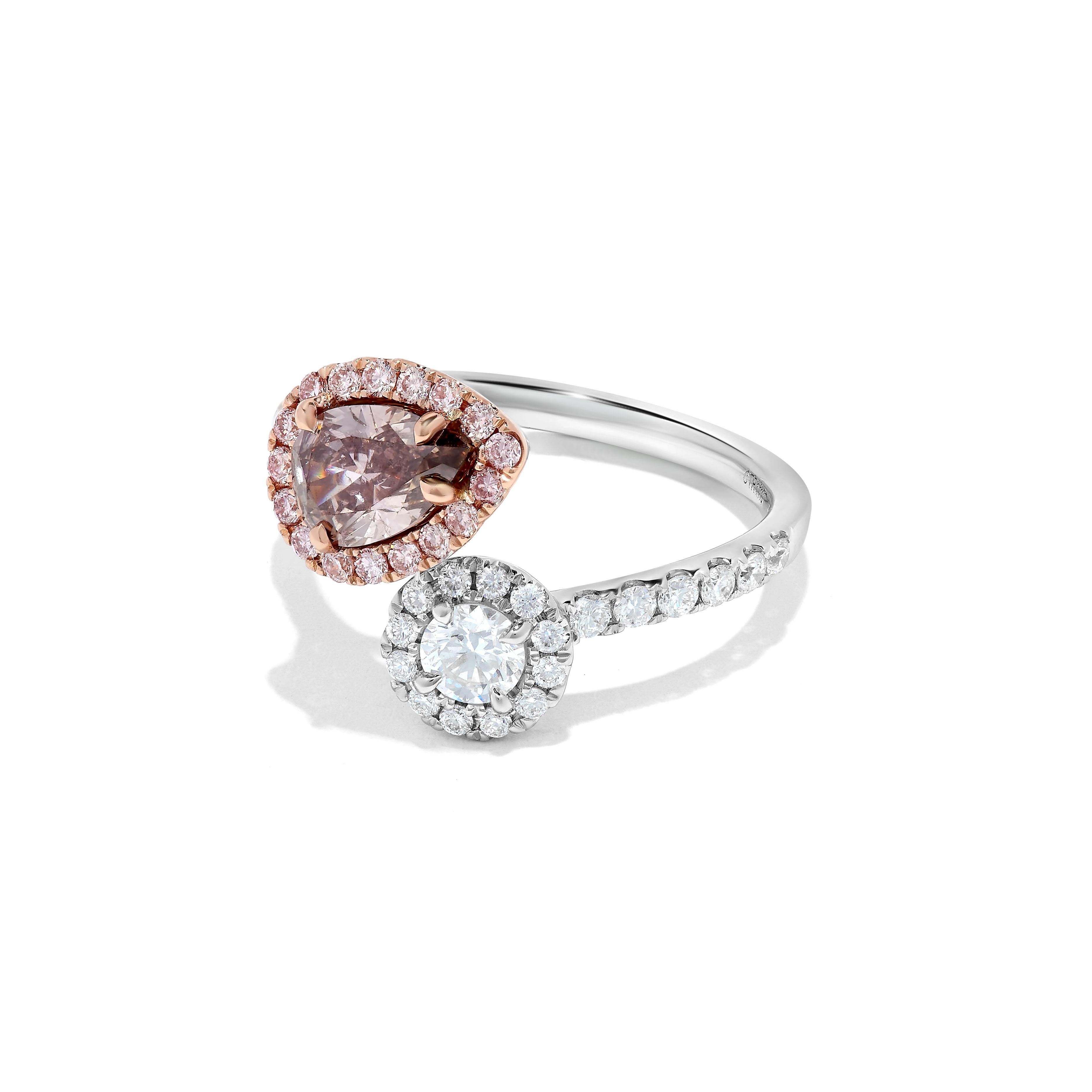 RareGemWorld's classic GIA certified diamond ring. Mounted in a beautiful 18K Rose and White Gold setting with a natural pear cut pink diamond as well as a natural round cut white diamond. These diamonds are surrounded by round natural pink diamond