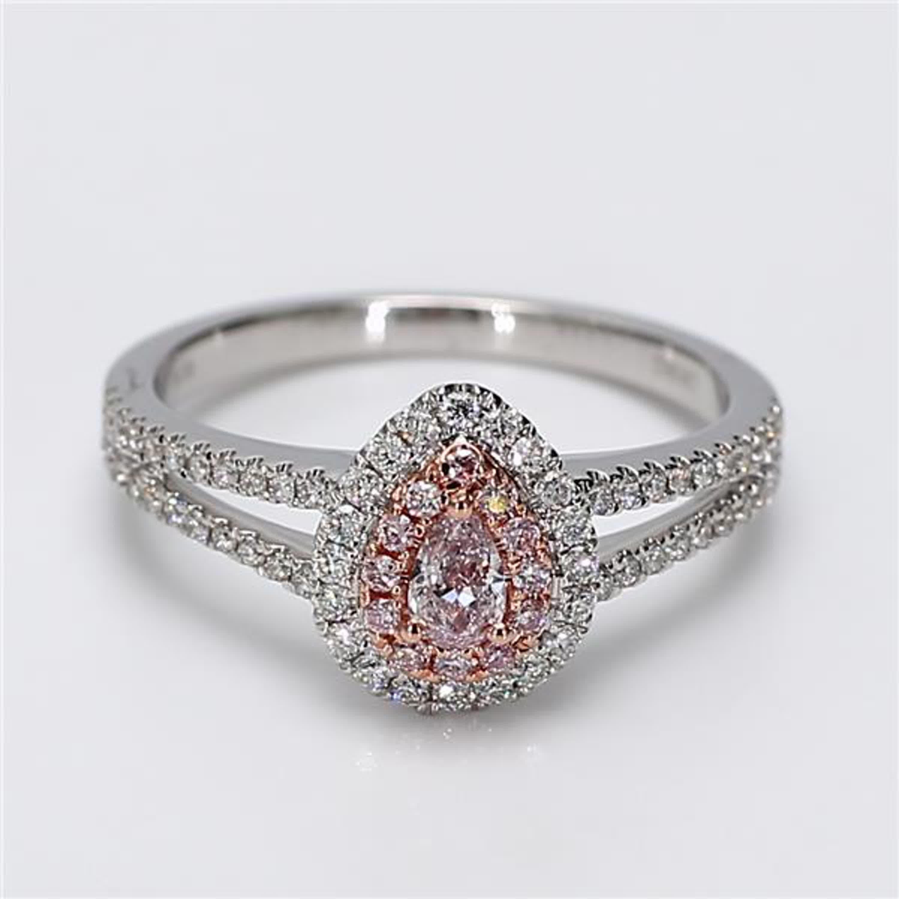 RareGemWorld's classic GIA certified diamond ring. Mounted in a beautiful 18K Rose and White Gold setting with a natural pear cut pink diamond. The pink diamond is surrounded by round natural pink diamond melee and round natural white diamond melee.
