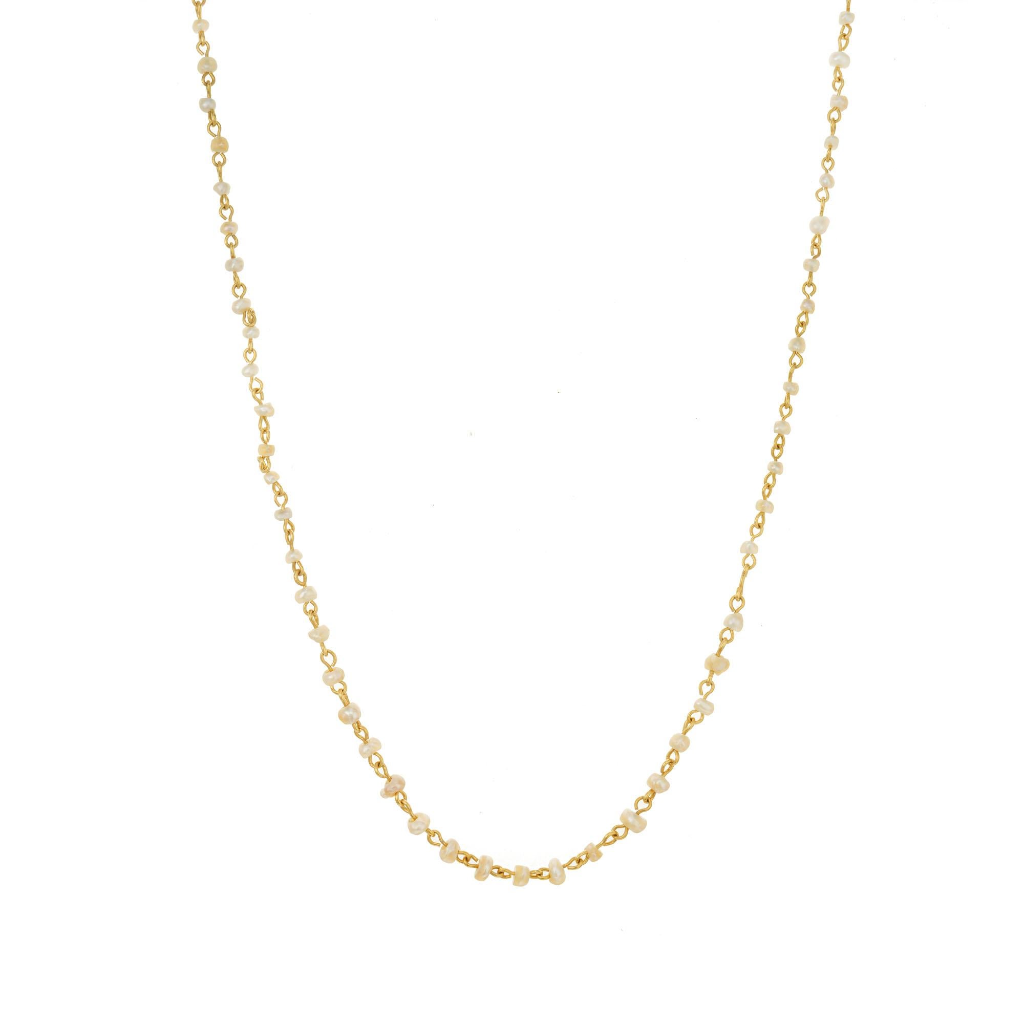 Turn of the Century 1900 handmade natural salt water pearl yellow gold necklace. 78 natural saltwater pearls connected by 14k yellow gold links. 21 inches long. 

78 natural white/creme saltwater pearls, 2.4mm- 4 mm GIA Certificate # 5211919386
14k