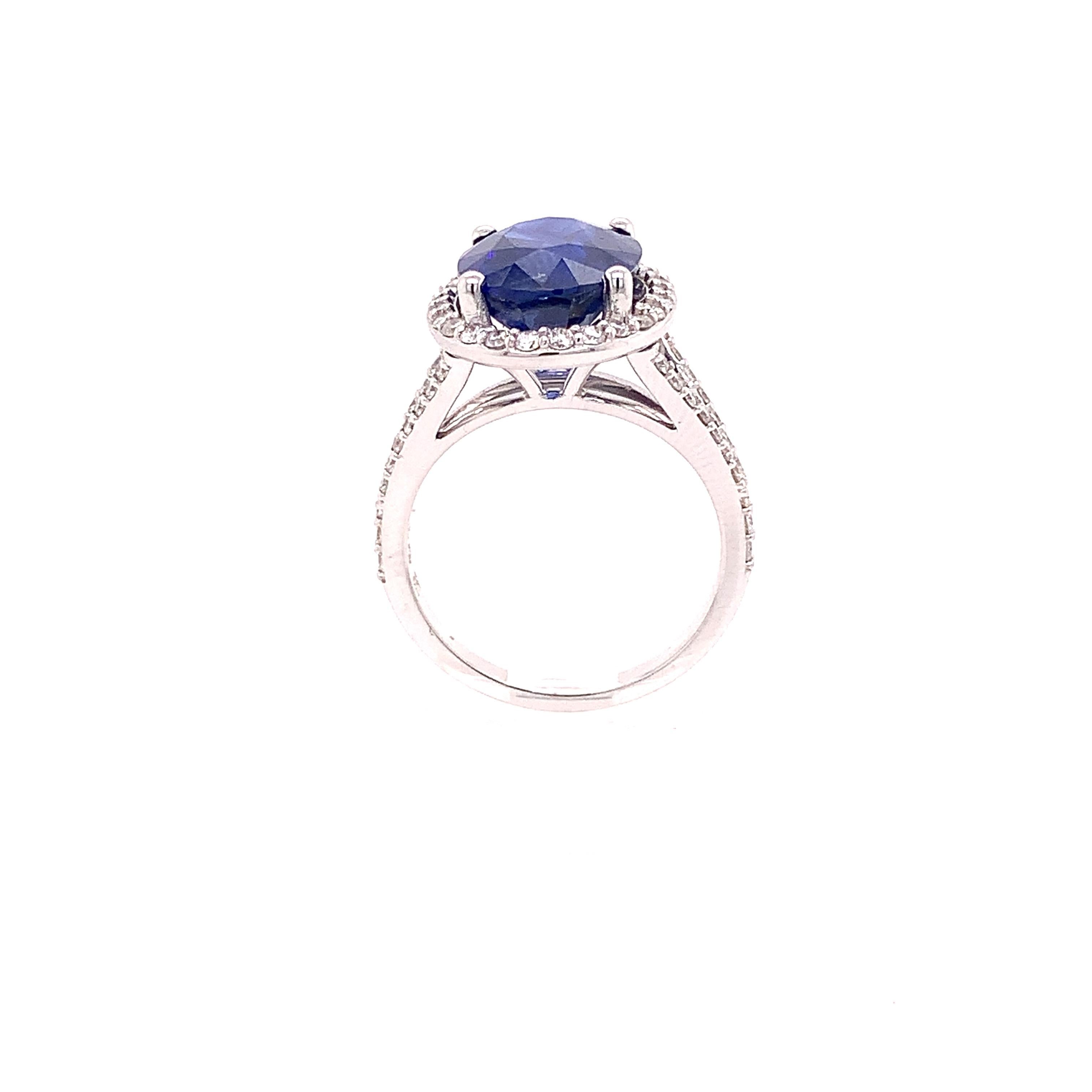 Stunning transparent oval natural blue sapphire and diamond ring crafted in 14 karat white gold with a beautiful halo and split shank.

This sapphire is GIA certified and has the original grading report. The blue sapphire is a natural heat-treated