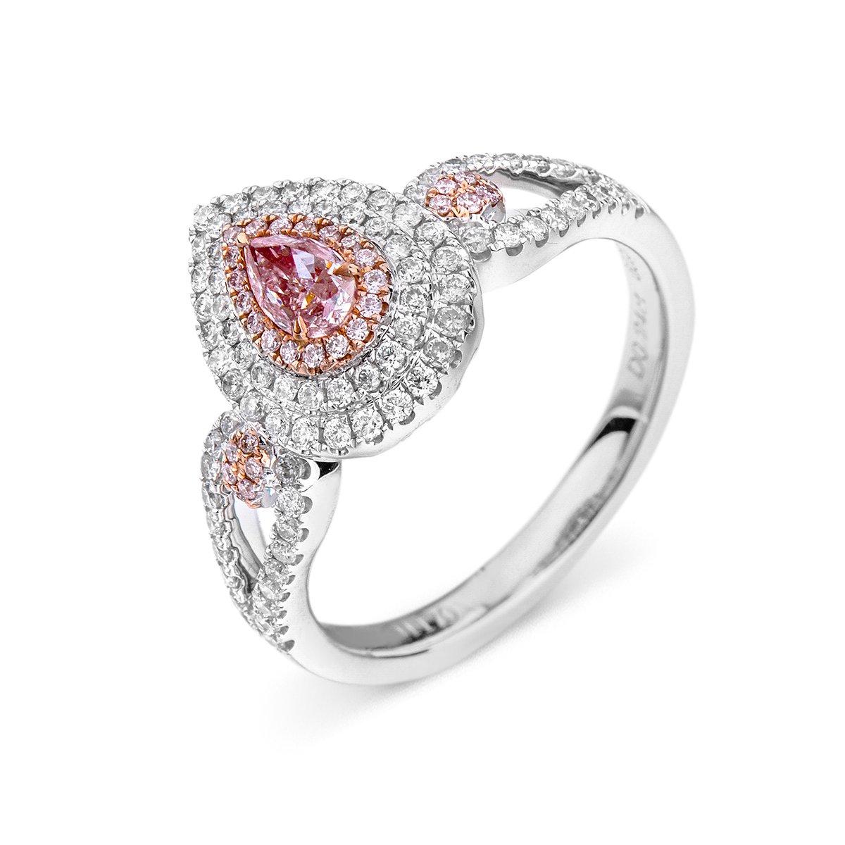 This unique piece consists of 0.24 carat natural pink diamonds, surrounded by smaller natural white diamonds making up a total of 0.75 Carats. It is GIA certified and has been expertly crafted using 18 Karat White Gold. 

The colour pink has long