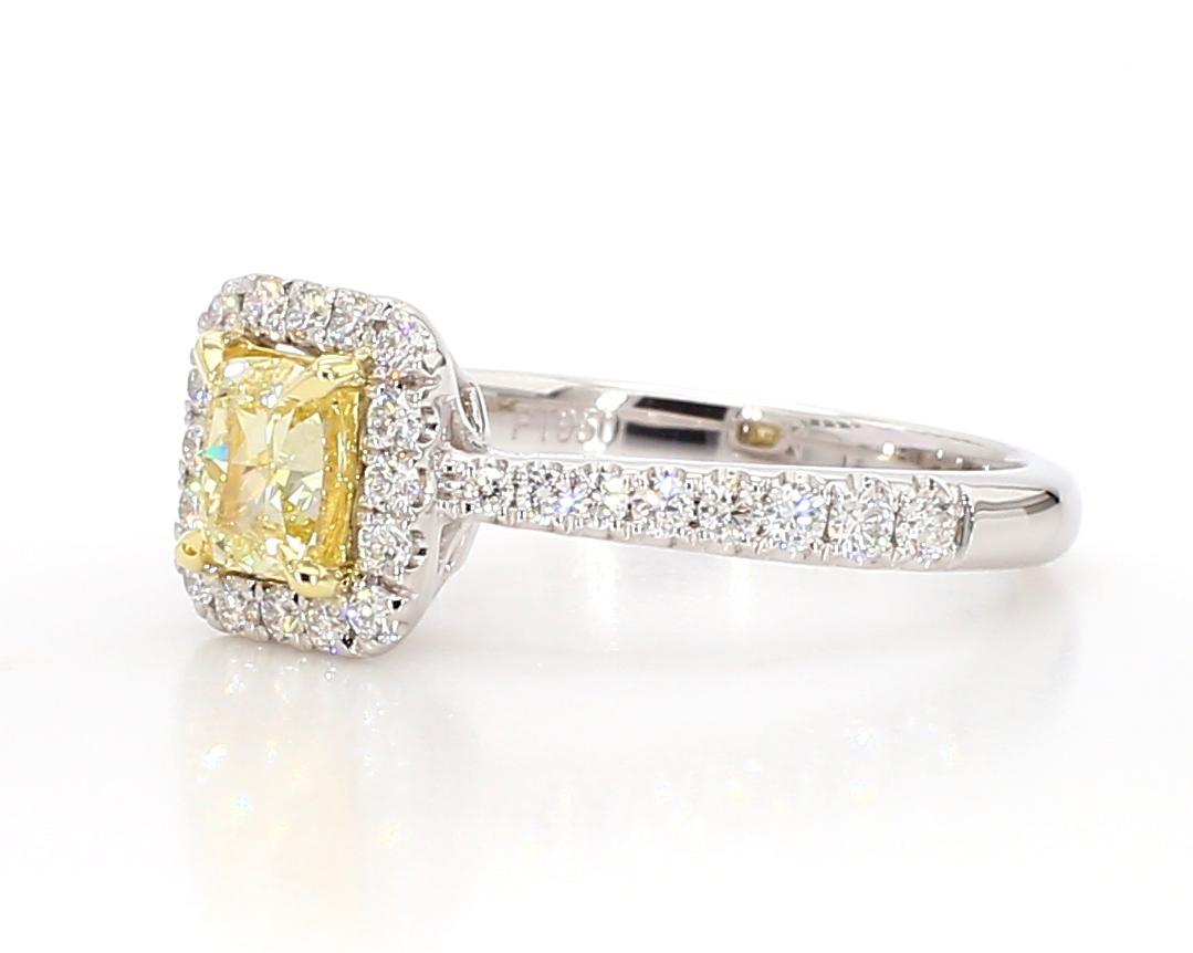 RareGemWorld's classic diamond ring. Mounted in a beautiful 18K Gold setting with a natural cushion cut yellow diamond. The yellow diamond is surrounded by round natural white diamond melee. This ring is guaranteed to impress and enhance your