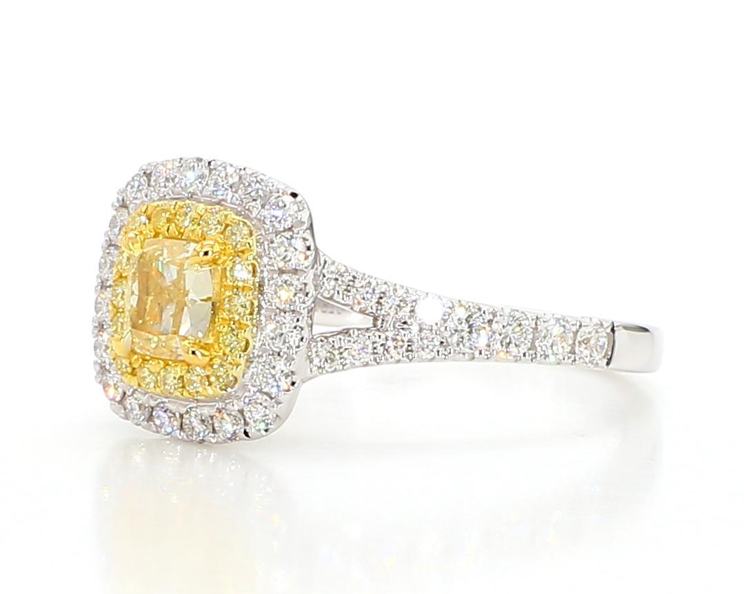 RareGemWorld's beautiful GIA certified diamond ring. Mounted in a beautiful 18K Yellow and White Gold setting with a natural cushion cut yellow diamond. The yellow diamond is surrounded by round natural yellow diamond melee and round natural white