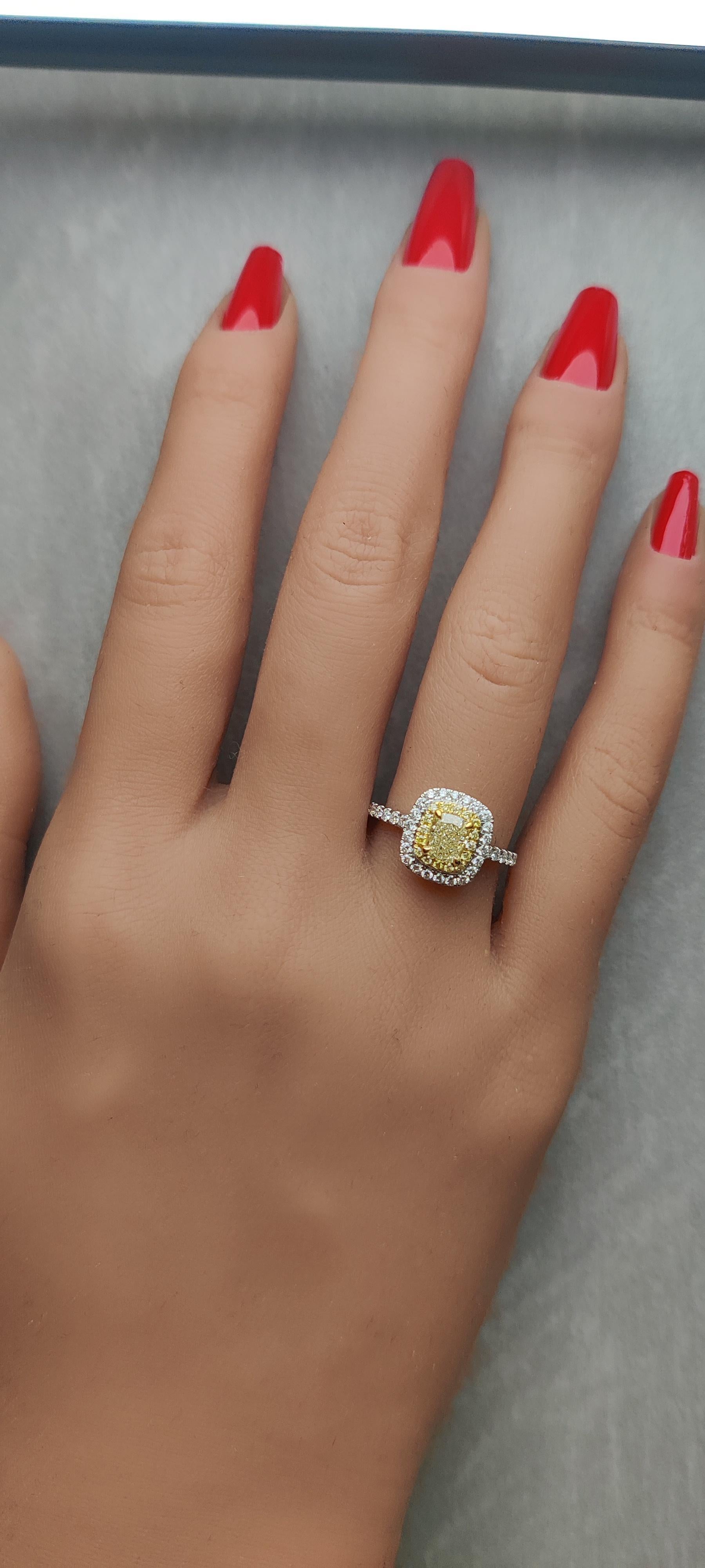 RareGemWorld's classic GIA certified diamond ring. Mounted in a beautiful 18K Yellow and White Gold setting with a natural cushion cut yellow diamond. The yellow diamond is surrounded by round natural yellow diamond melee and round natural white