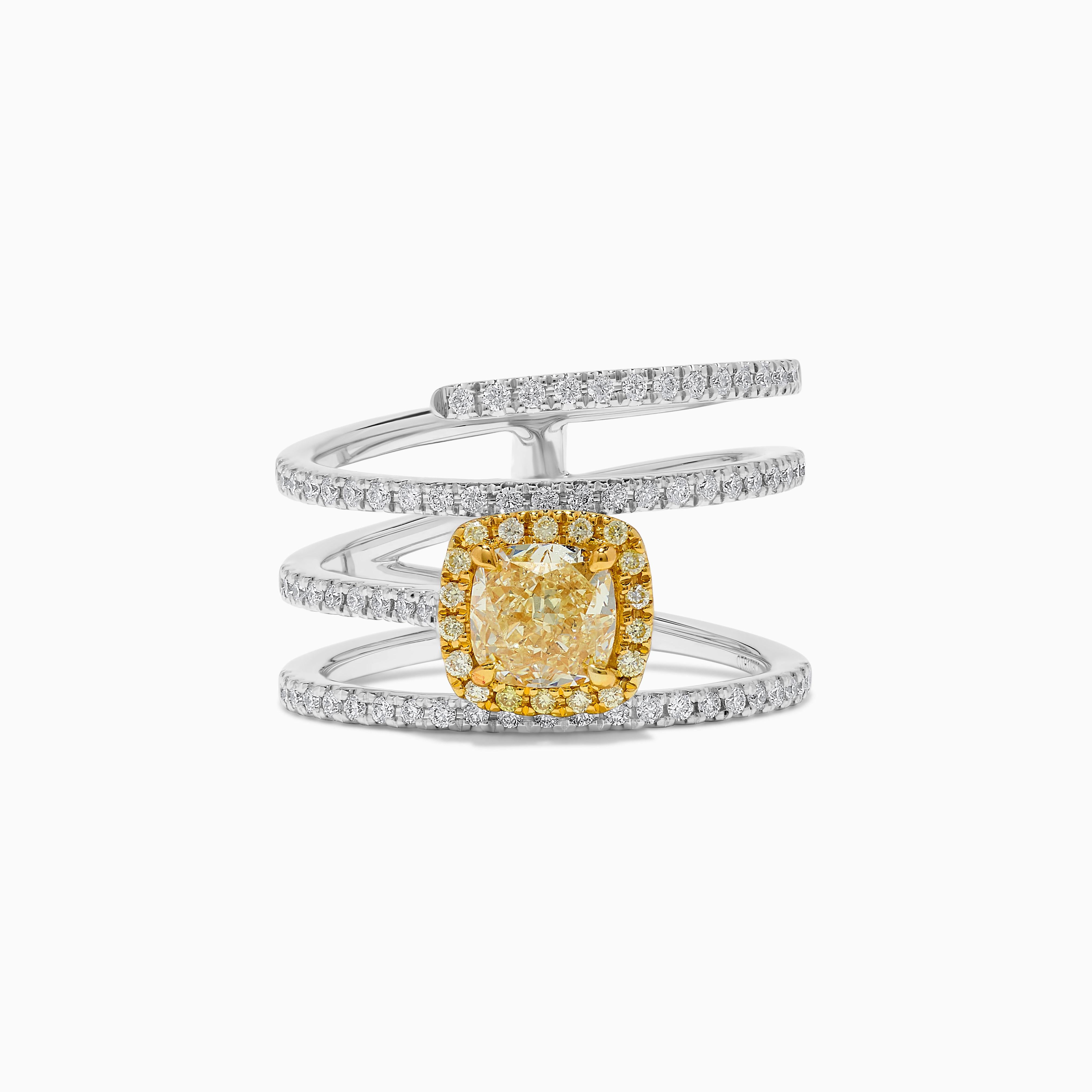 RareGemWorld's classic GIA certified diamond ring. Mounted in a beautiful 18K Yellow and White Gold setting with a natural cushion cut yellow diamond. The yellow diamond is surrounded by round natural white diamond melee and natural round yellow
