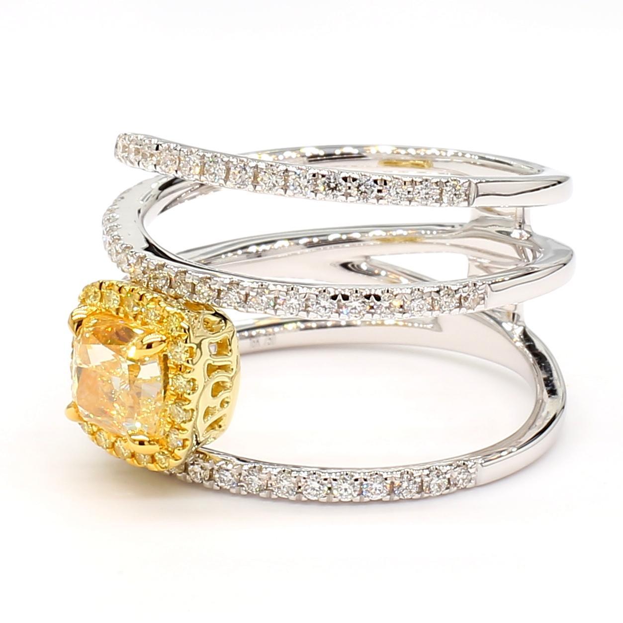 RareGemWorld's beautiful GIA certified diamond ring. Mounted in a beautiful 18K Yellow and White Gold setting with a natural cushion cut yellow diamond. The yellow diamond is surrounded by round natural yellow diamond melee and round natural white