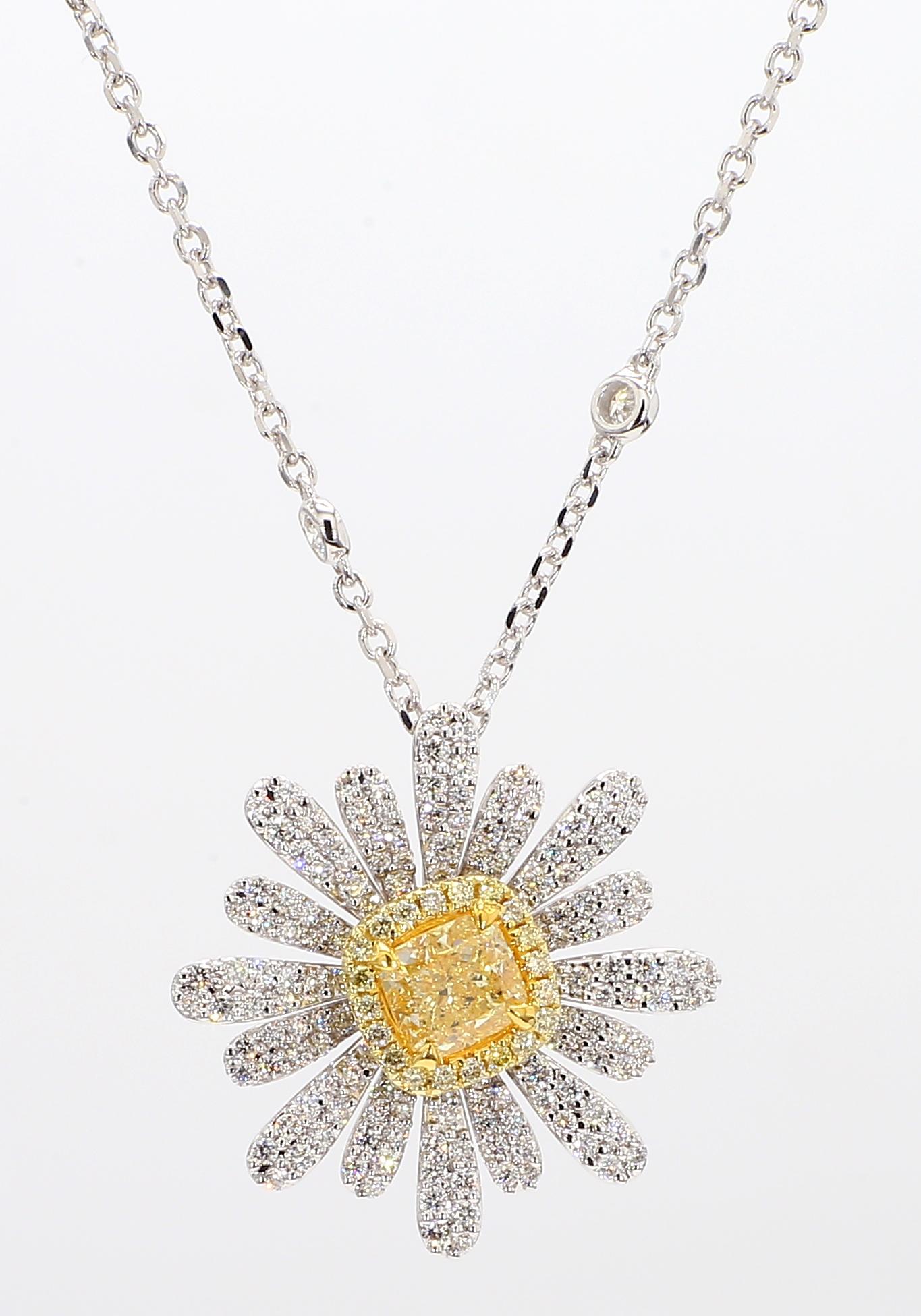 RareGemWorld's intriguing GIA certified diamond pendant. Mounted in a beautiful 18K Yellow and White Gold setting with a natural cushion cut yellow diamond. The yellow diamond is surrounded by round natural yellow diamond melee and round natural