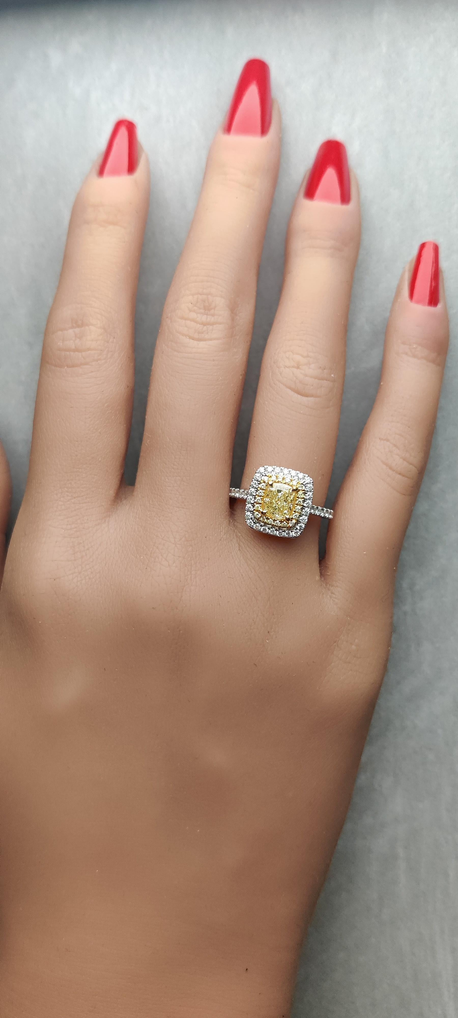 RareGemWorld's classic GIA certified diamond ring. Mounted in a beautiful 18K Yellow and White Gold setting with a natural cushion cut yellow diamond. The yellow diamond is surrounded by round natural yellow diamond melee and round natural white