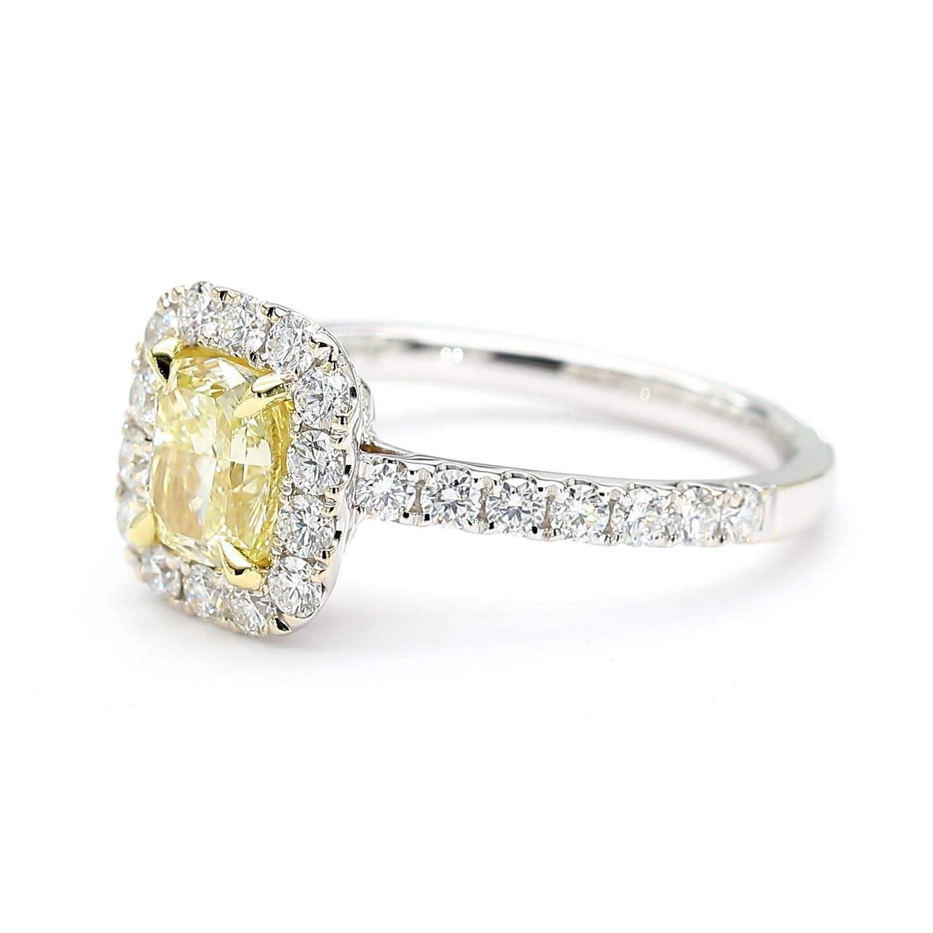 RareGemWorld's beautiful diamond ring. Mounted in a beautiful 18K Yellow and White Gold setting with a natural cushion cut yellow diamond. The yellow diamond is surrounded by round natural white diamond melee. This ring is guaranteed to impress and