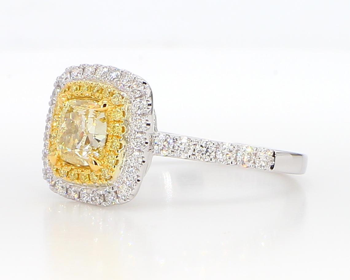 RareGemWorld's beautiful GIA certified diamond ring. Mounted in a beautiful 18K Yellow and White Gold setting with a natural cushion cut yellow diamond. The yellow diamond is surrounded by round natural yellow diamond melee and round natural white