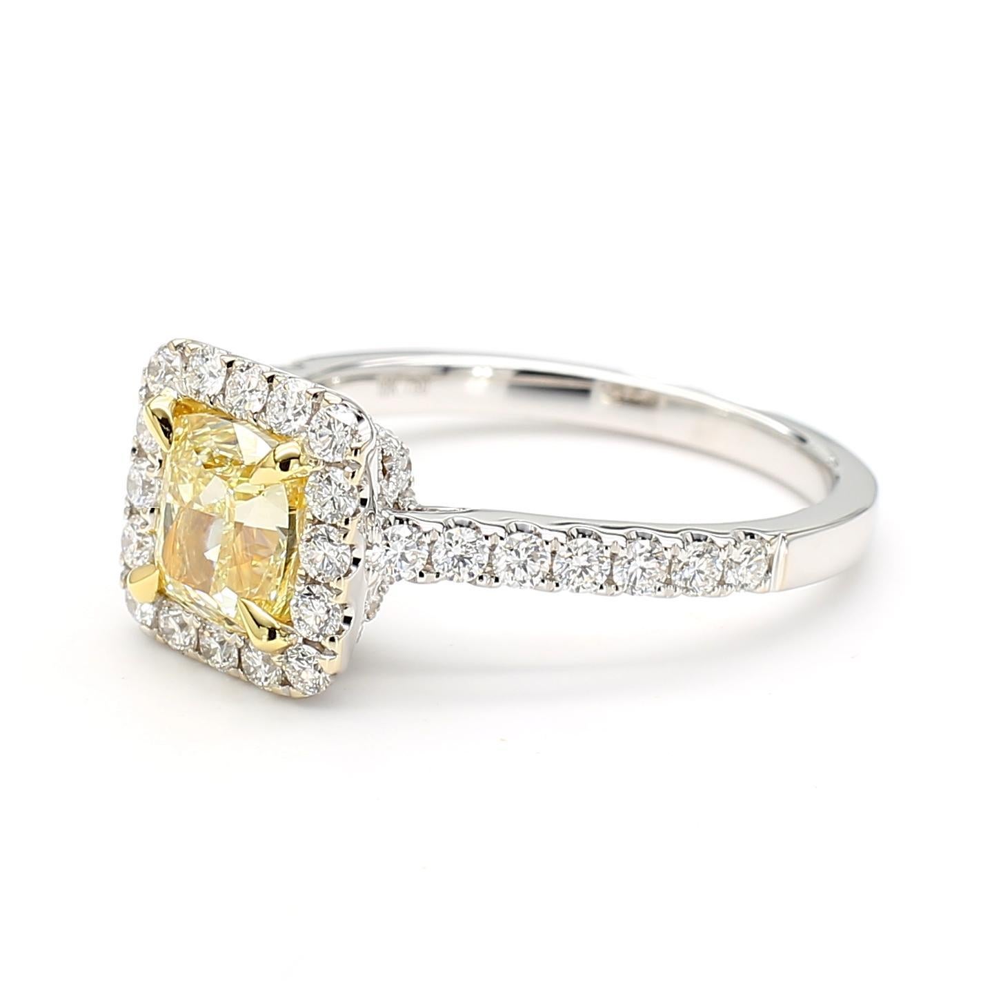 RareGemWorld's beautiful GIA Certified diamond ring. Mounted in a beautiful 18K Yellow and White Gold setting with a natural cushion cut yellow diamond. The yellow diamond is surrounded by round natural white diamond melee. This ring is guaranteed