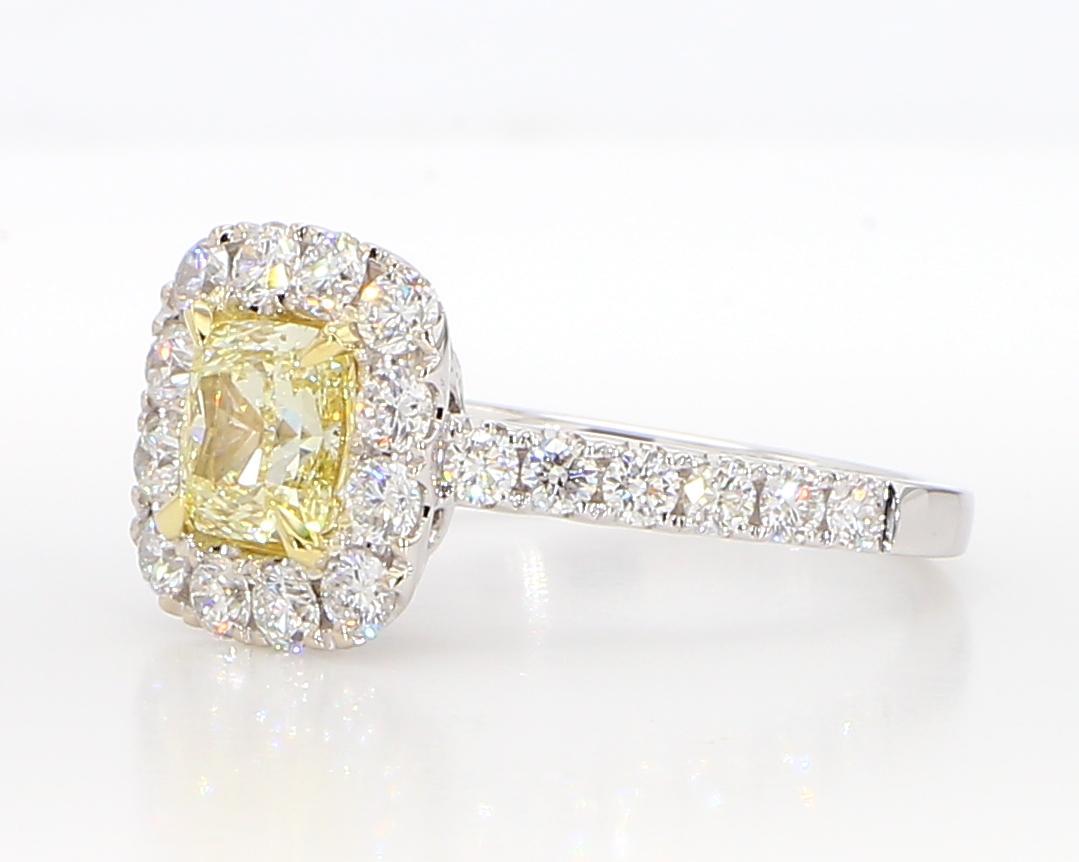 RareGemWorld's beautiful GIA Certified diamond ring. Mounted in a beautiful 18K Yellow and White Gold setting with a natural cushion cut yellow diamond. The yellow diamond is surrounded by round natural white diamond melee. This ring is guaranteed