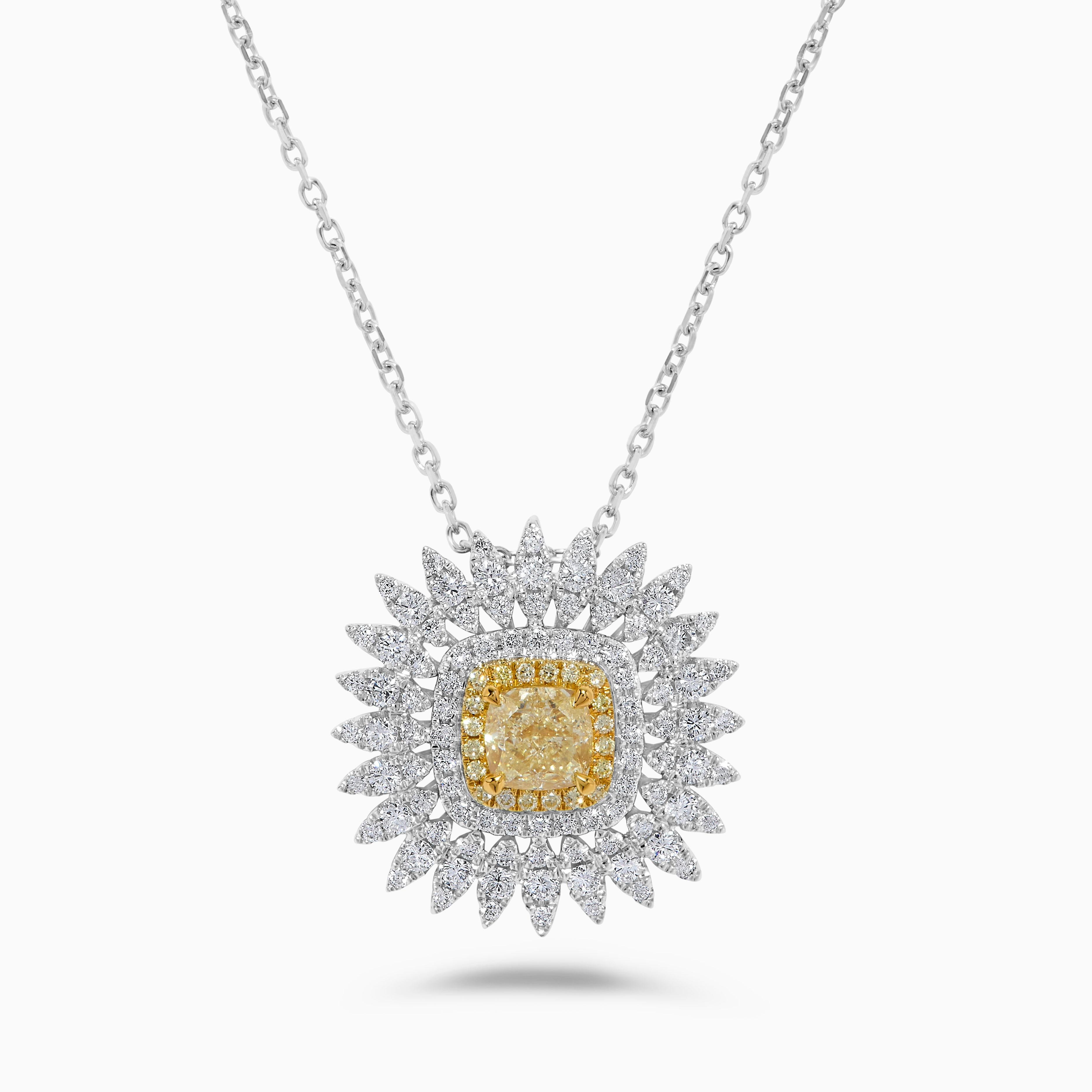 RareGemWorld's intriguing GIA certified diamond pendant. Mounted in a beautiful 18K Yellow and White Gold setting with a natural cushion cut yellow diamond. The yellow diamond is surrounded by round natural yellow diamond melee and round natural