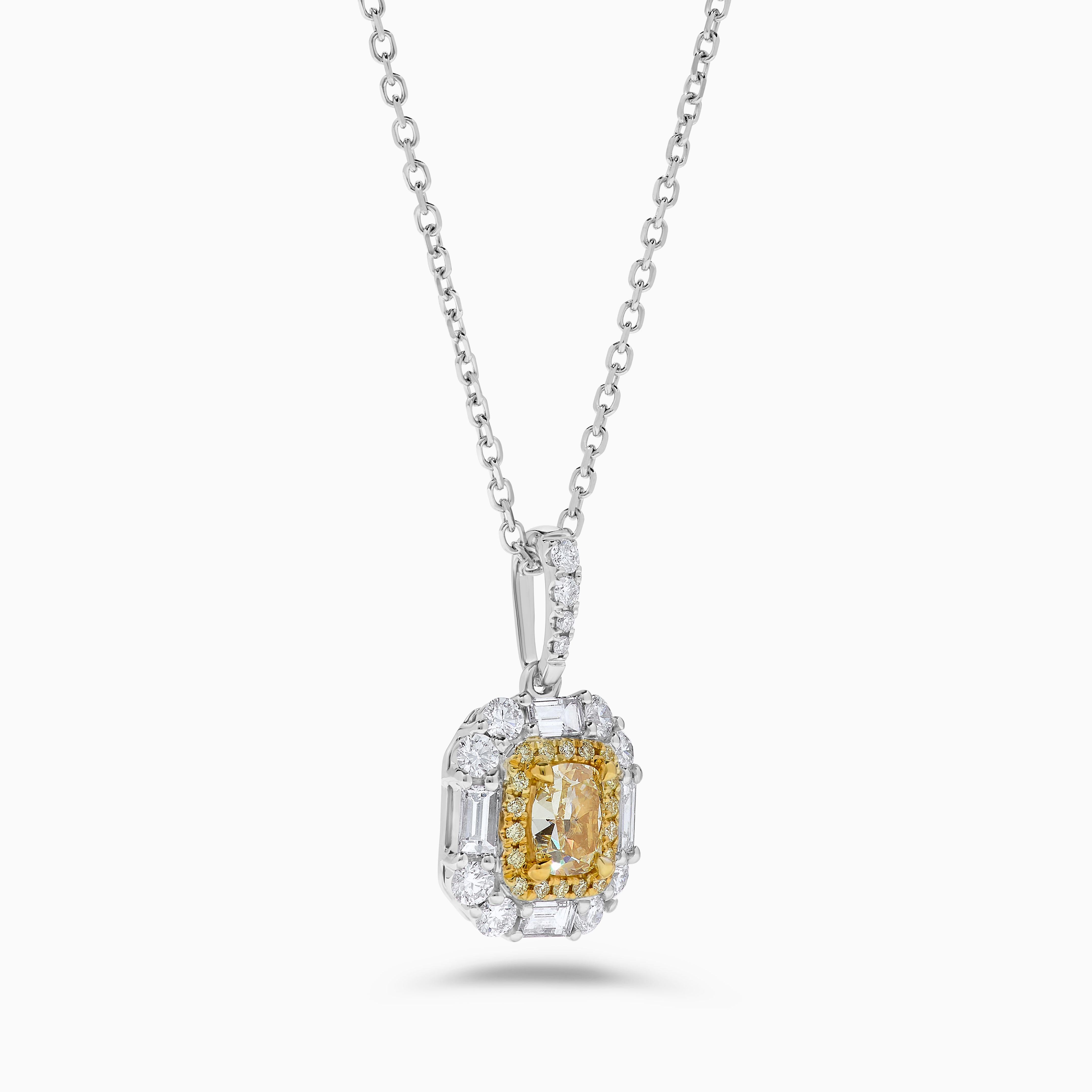 RareGemWorld's intriguing GIA certified diamond pendant. Mounted in a beautiful 18K Yellow and White Gold setting with a natural cushion cut yellow diamond. The yellow diamond is surrounded by natural baguette cut white diamonds, round natural