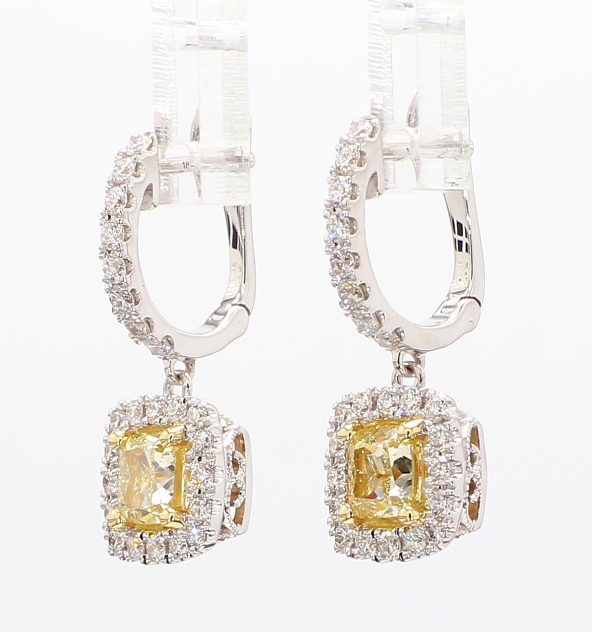 RareGemWorld's beautiful diamond earrings. Mounted in a beautiful 18K Yellow and White Gold setting with natural cushion cut yellow diamonds. The yellow diamonds are surrounded by round natural white diamond melee. These earrings are guaranteed to