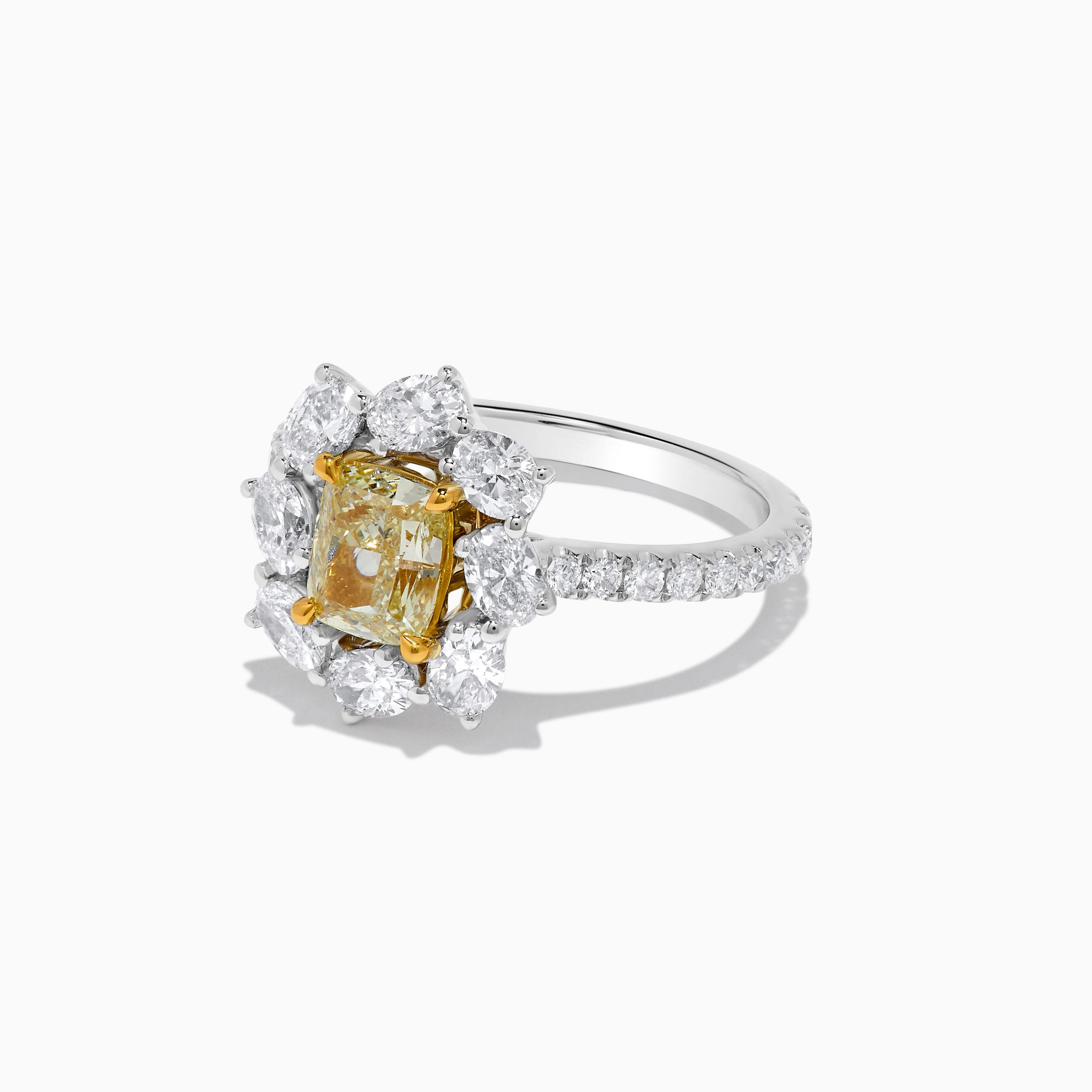 RareGemWorld's classic GIA certified diamond ring. Mounted in a beautiful 18K Yellow and White Gold setting with a natural cushion cut yellow diamond. The yellow diamond is surrounded by natural oval cut white diamonds and round natural white