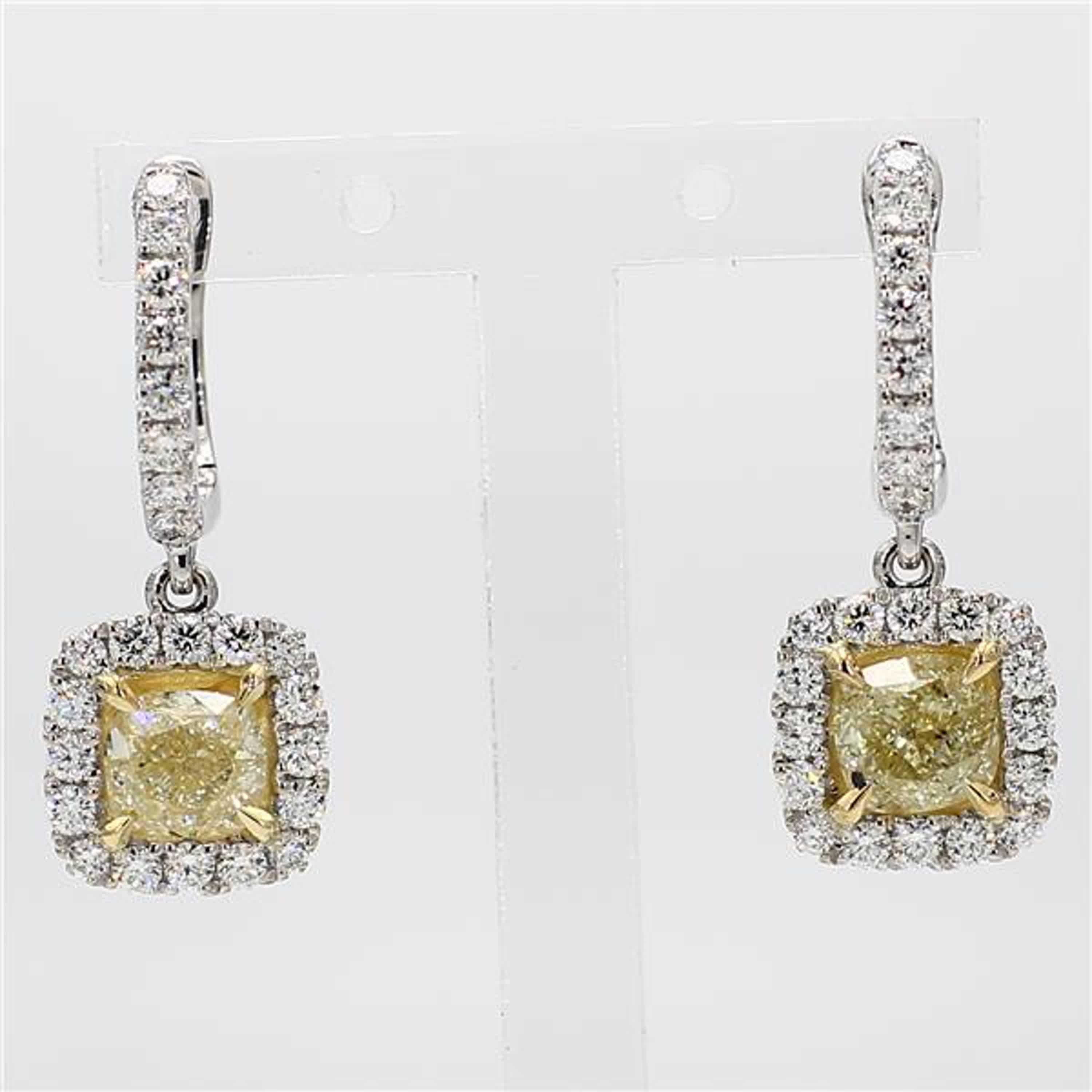 RareGemWorld's classic GIA certified diamond earrings. Mounted in a beautiful 18K Yellow and White Gold setting with natural cushion cut yellow diamonds. The yellow diamonds are surrounded by round natural white diamond melee. These earrings are