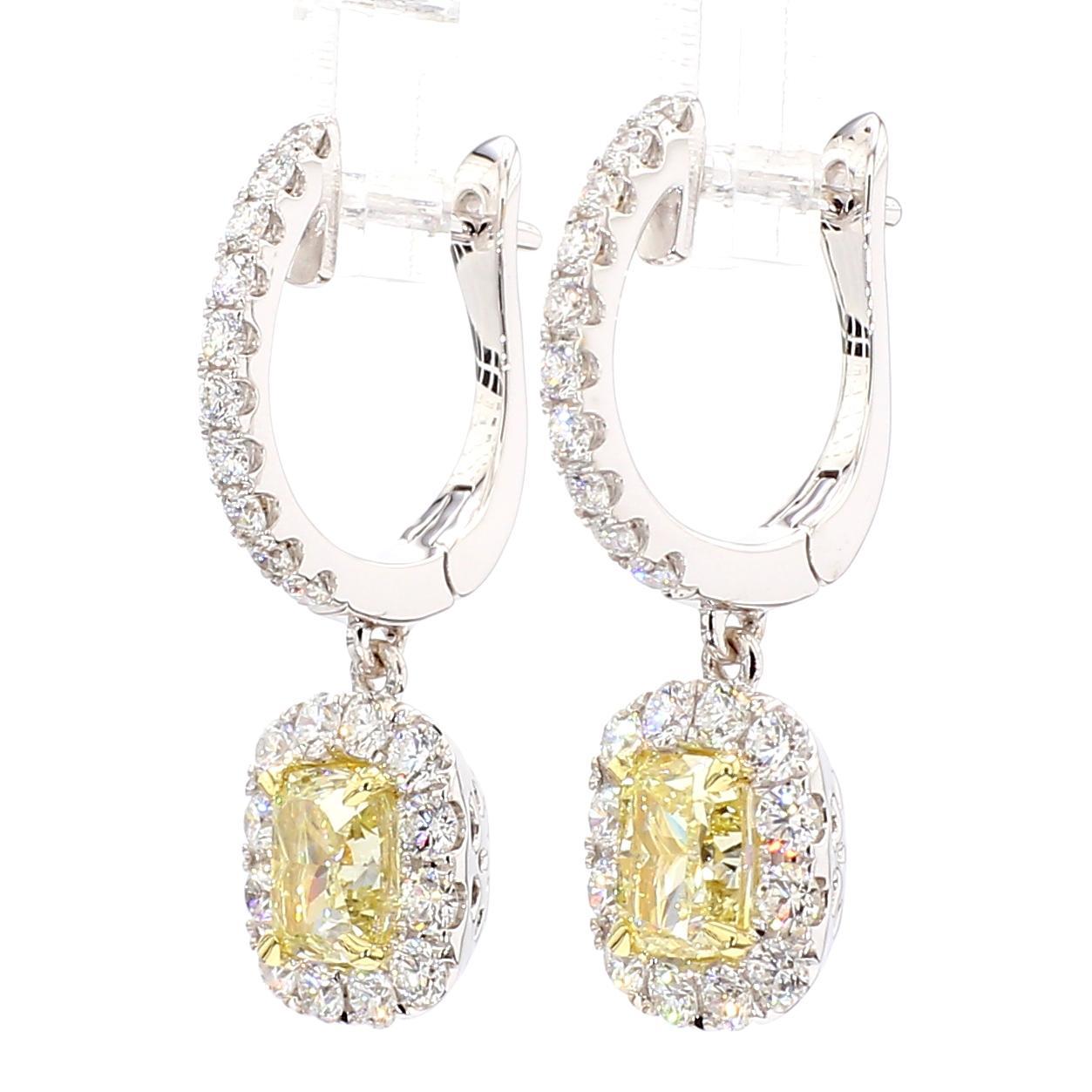 RareGemWorld's beautiful GIA certified diamond earrings. Mounted in a beautiful 18K Yellow and White Gold setting with natural cushion cut yellow diamonds. The yellow diamonds are surrounded by round natural white diamond melee. These earrings are