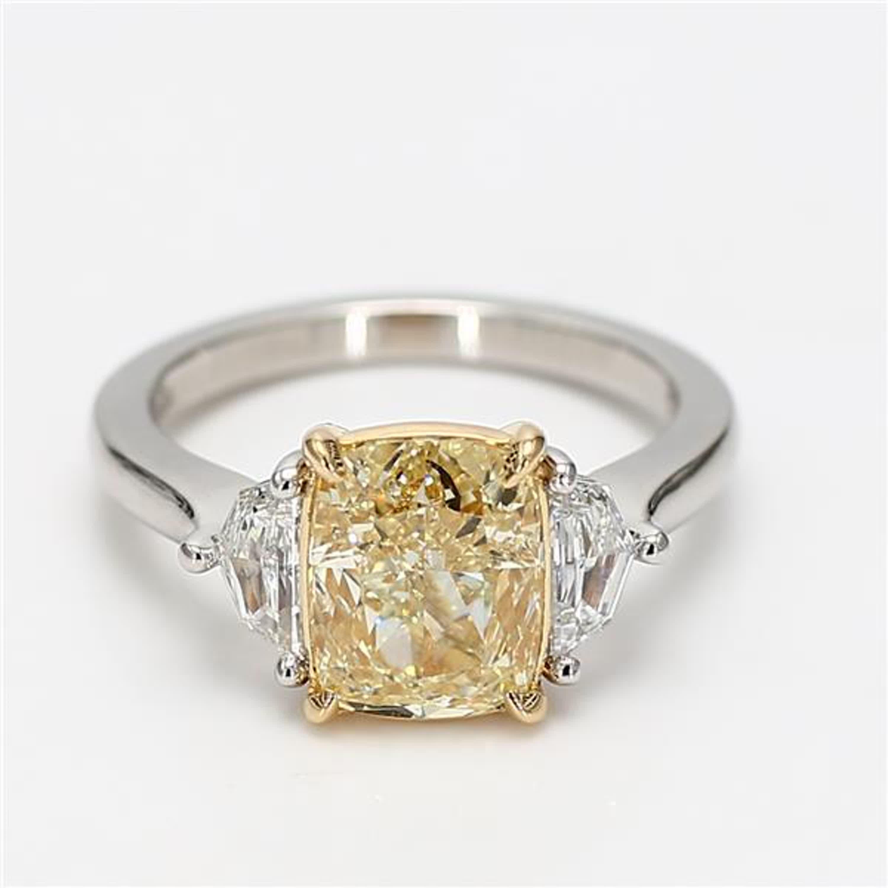 RareGemWorld's classic GIA certified diamond ring. Mounted in a beautiful Platinum and 18K Gold setting with a natural cushion cut yellow diamond. The yellow diamond is surrounded by natural epaulette cut white diamonds. This ring is guaranteed to