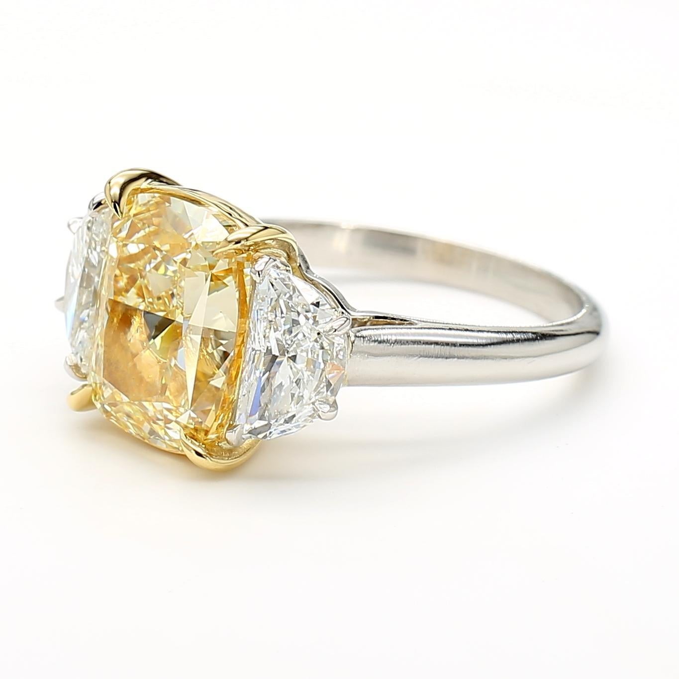 RareGemWorld's beautiful GIA certified diamond ring. Mounted in a beautiful platinum setting with a natural cushion cut yellow diamond. The yellow diamond is surrounded by natural half-moon cut white diamonds. This ring is guaranteed to impress and