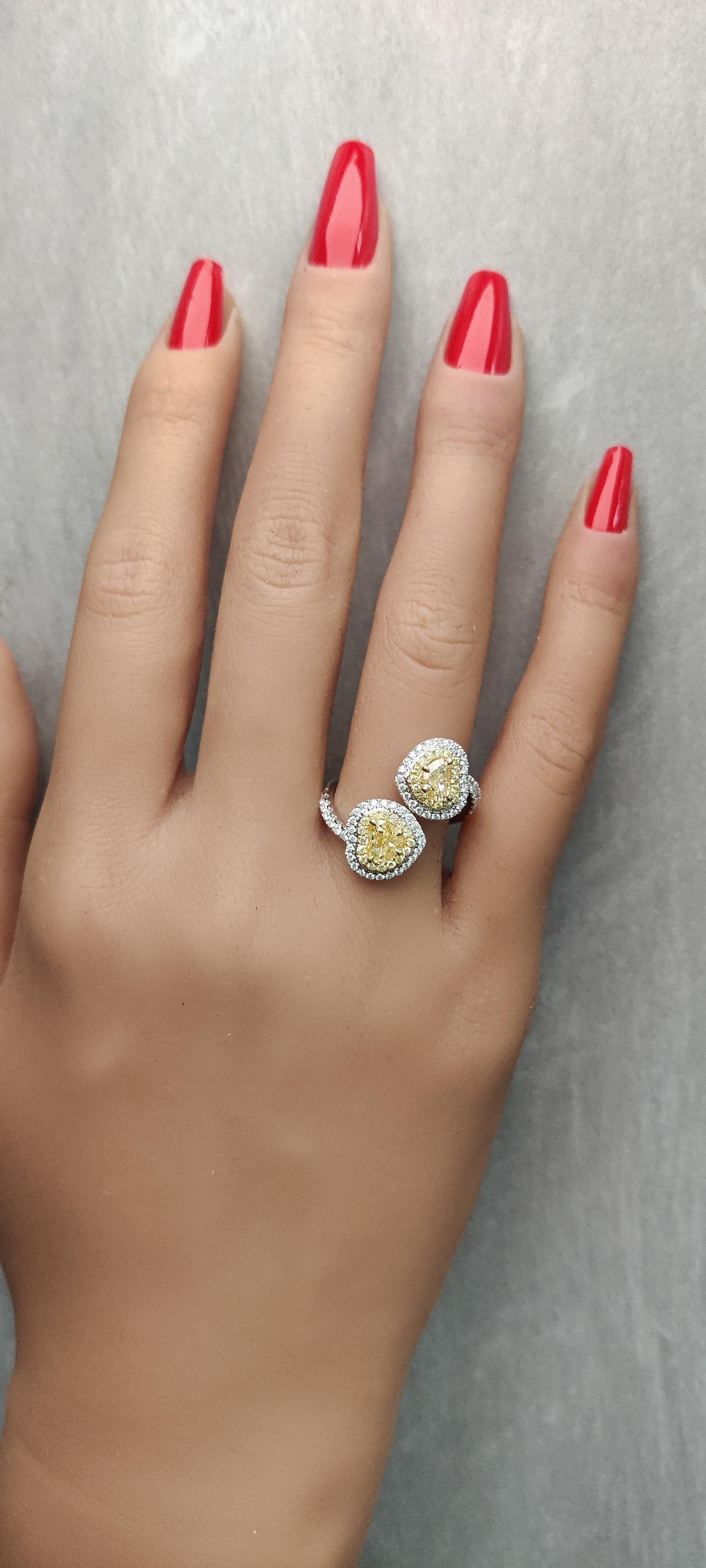 RareGemWorld's classic GIA certified diamond ring. Mounted in a beautiful 18K Yellow and White setting with two natural heart cut yellow diamonds. The yellow diamonds are surrounded by round natural white diamond melee and round natural yellow