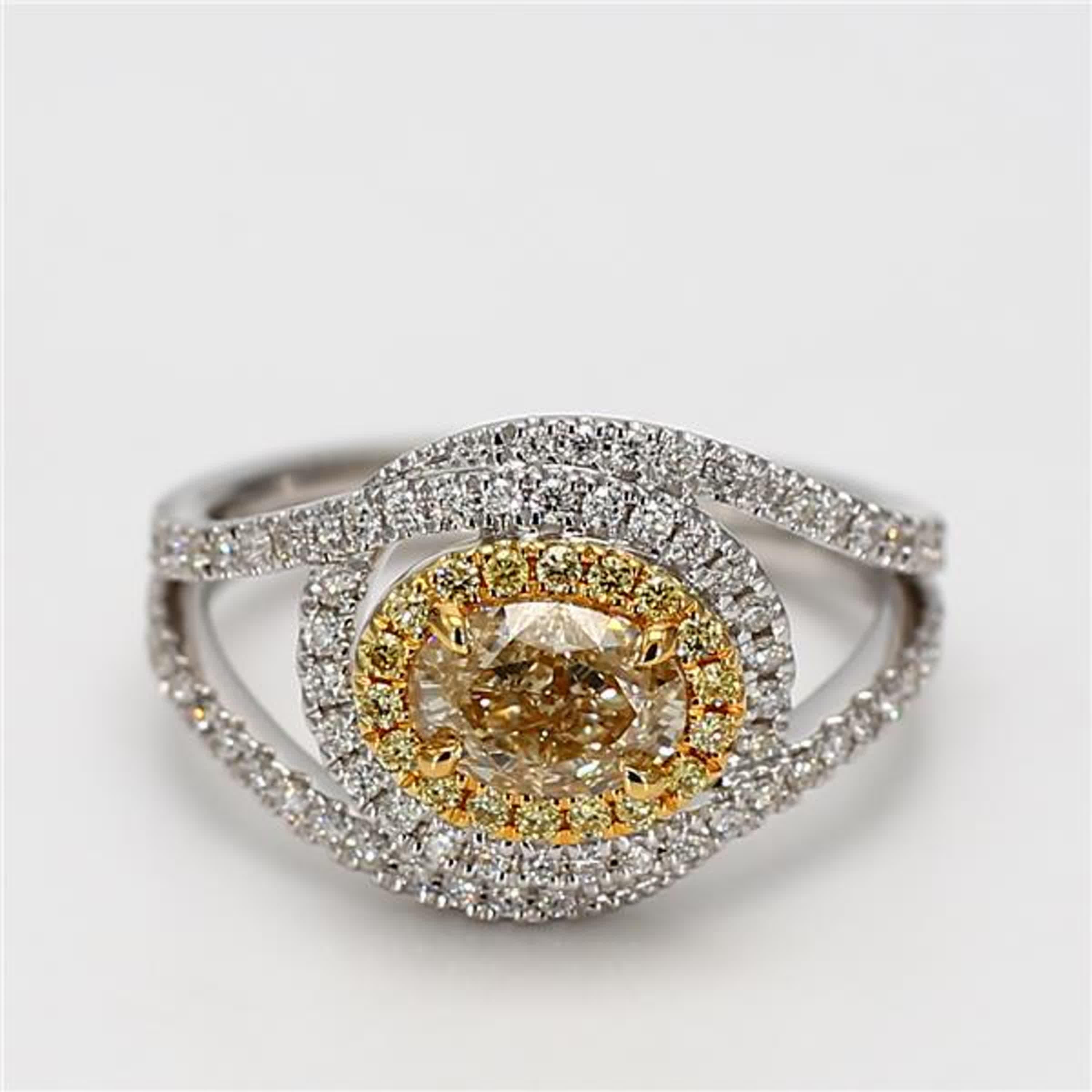 RareGemWorld's classic GIA certified diamond ring. Mounted in a beautiful 18K Yellow and White Gold setting with a natural oval cut yellow diamond. The yellow diamond is surrounded by round natural yellow diamond melee and round natural white