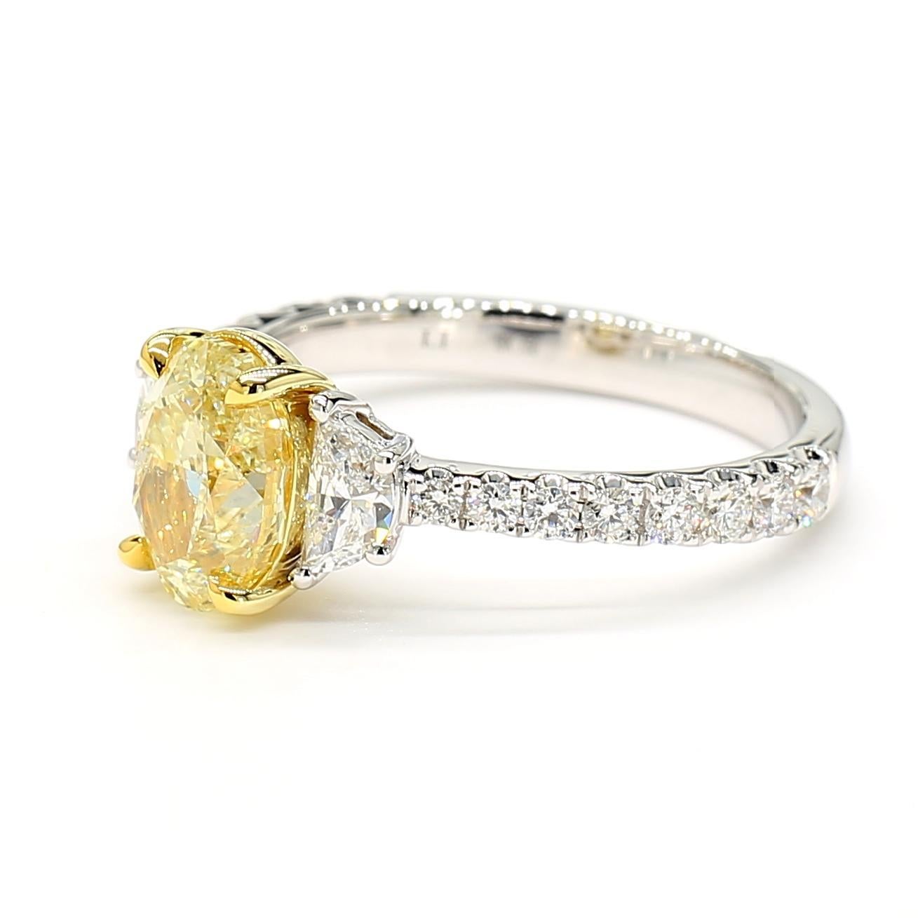 RareGemWorld's beautiful GIA certified diamond ring. Mounted in a beautiful 18K Yellow and White Gold setting with a natural oval cut yellow diamond. The yellow diamond is surrounded by natural half-moon cut white diamond and round natural white