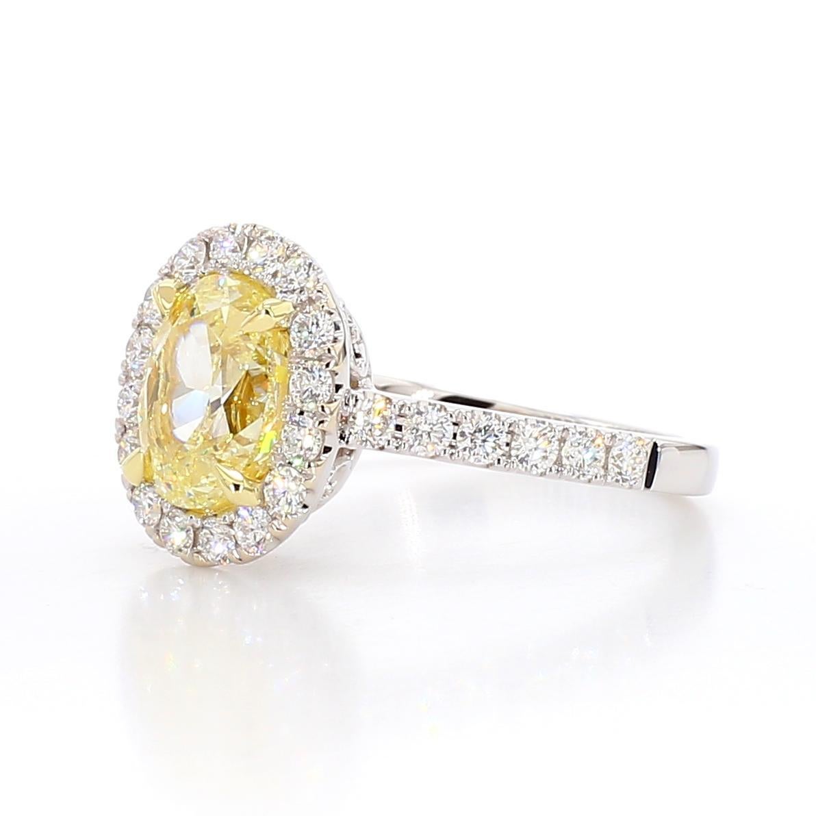 RareGemWorld's beautiful GIA certified diamond ring. Mounted in a beautiful 18K Yellow and White Gold setting with a natural oval cut yellow diamond. The yellow diamond is surrounded by small round natural white diamond melee. This ring is