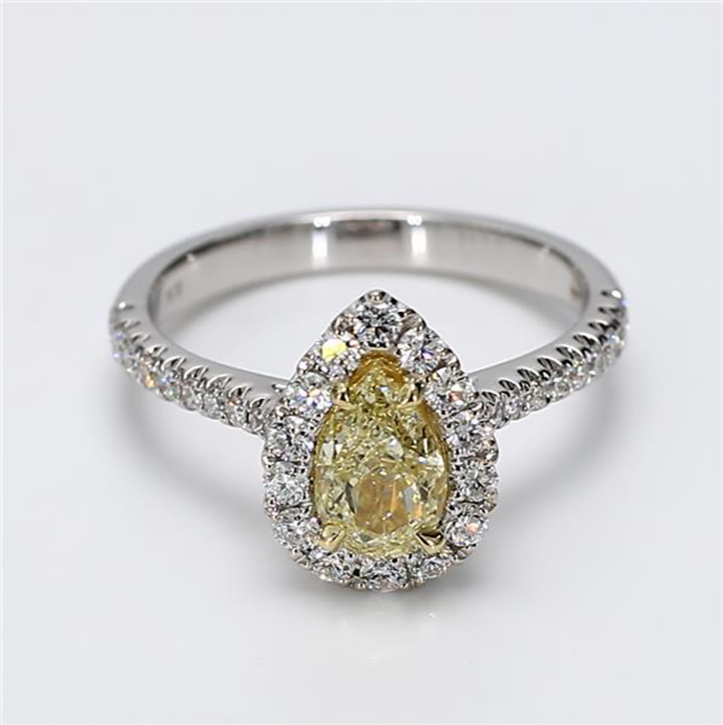 RareGemWorld's classic GIA certified diamond ring. Mounted in a beautiful 18K Yellow and White Gold setting with a natural pear cut yellow diamond. The yellow diamond is surrounded by small round natural white diamond melee. This ring is guaranteed